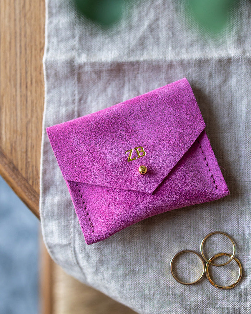 Pink suede personalised jewellery pouch with stacking rings.