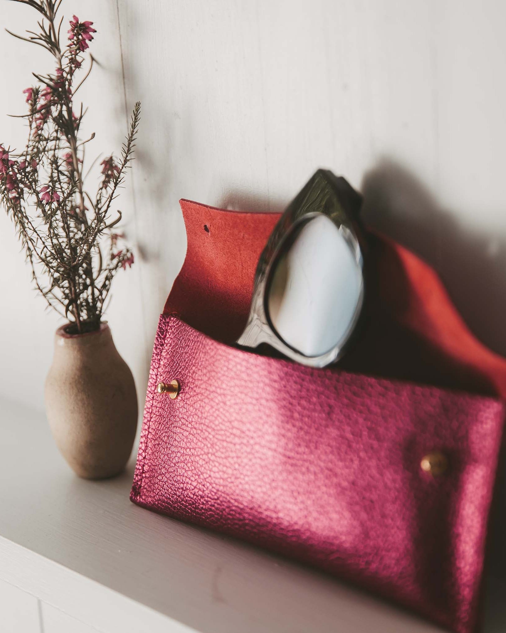 Cream recycled leather glasses case with cream sunglasses.