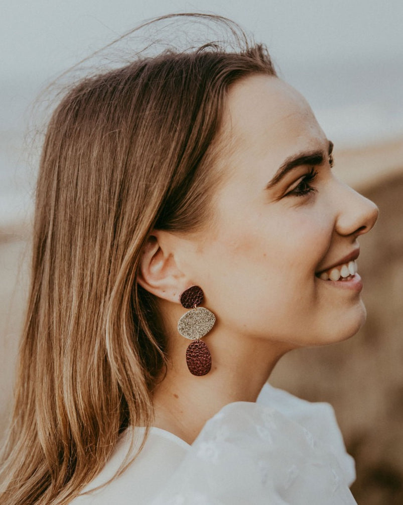 Nessa Pebble Earrings in statement gold and burgundy.