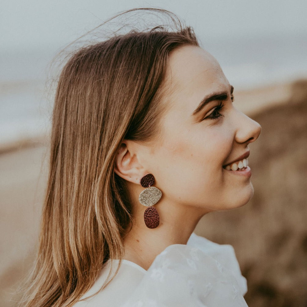 Nessa Pebble Earrings in statement gold and burgundy.
