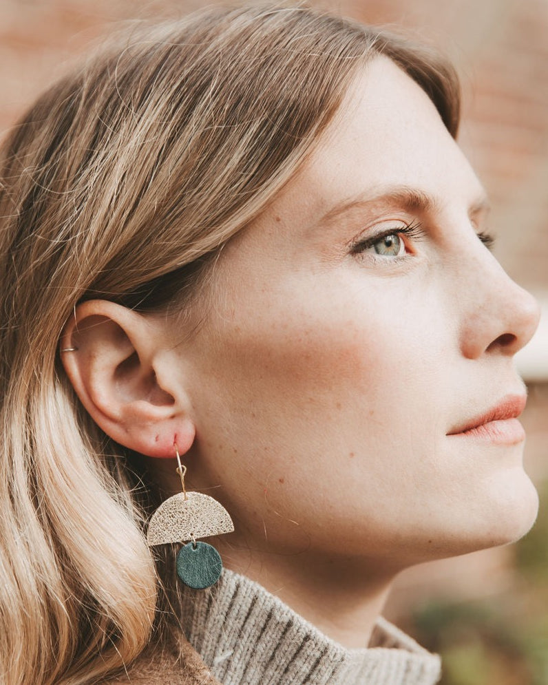 Model wearing the leather sunrise hoops in forest green