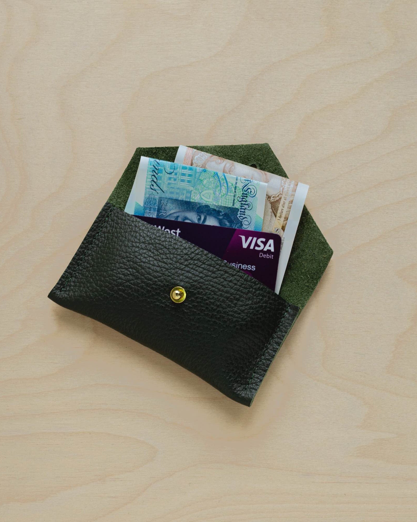 Pine Green leather card holder in use.