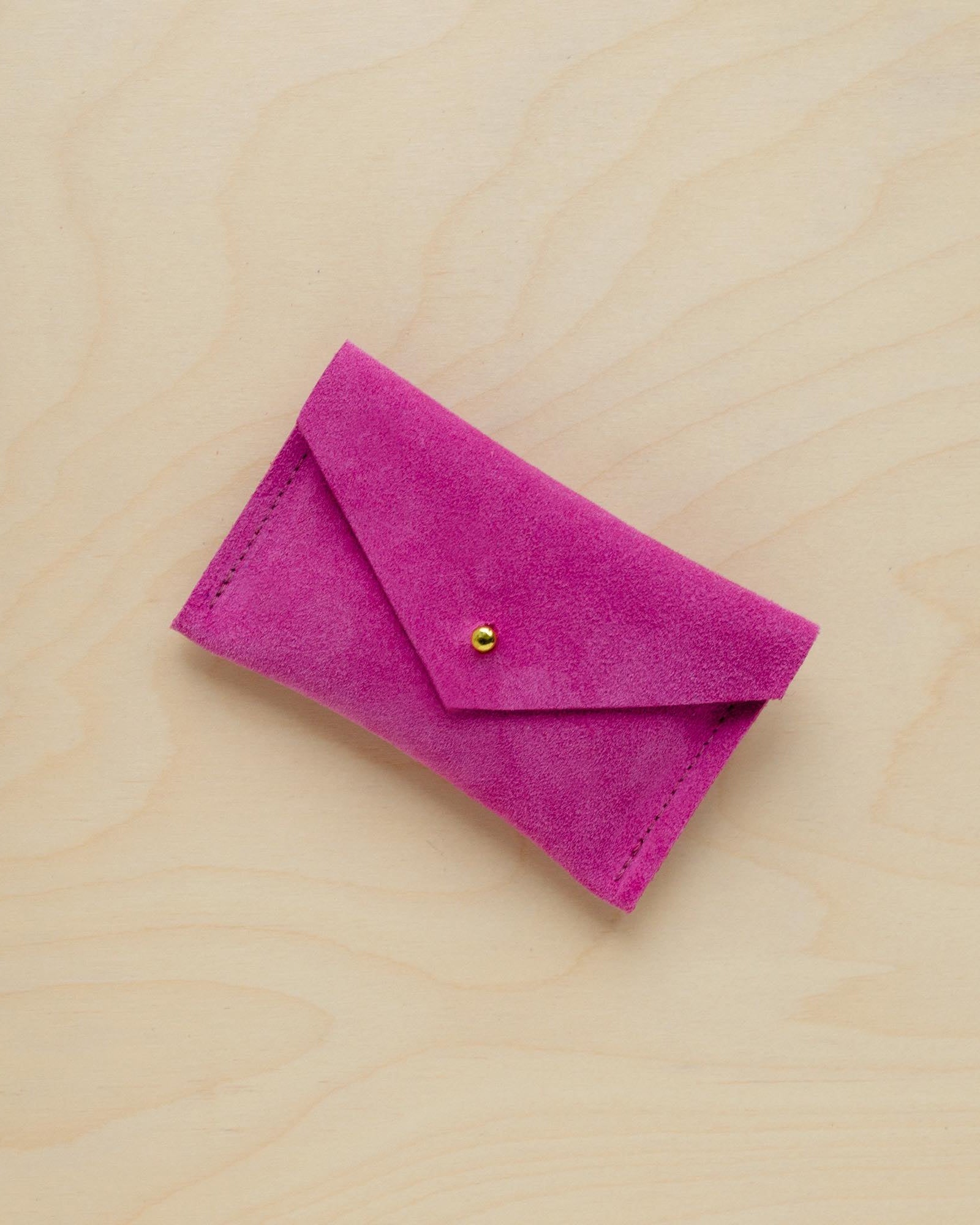 A suede Small Notions Pouch in Fuchsia Pink. Complete with a stud for secure closing.