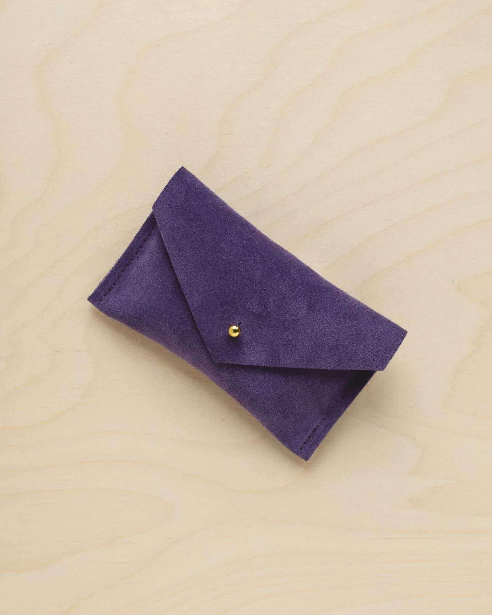 A suede Small Notions Pouch in Grape Purple. Complete with a stud for secure closing.