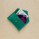 Bright Green suede purse with money and credit cards in it.