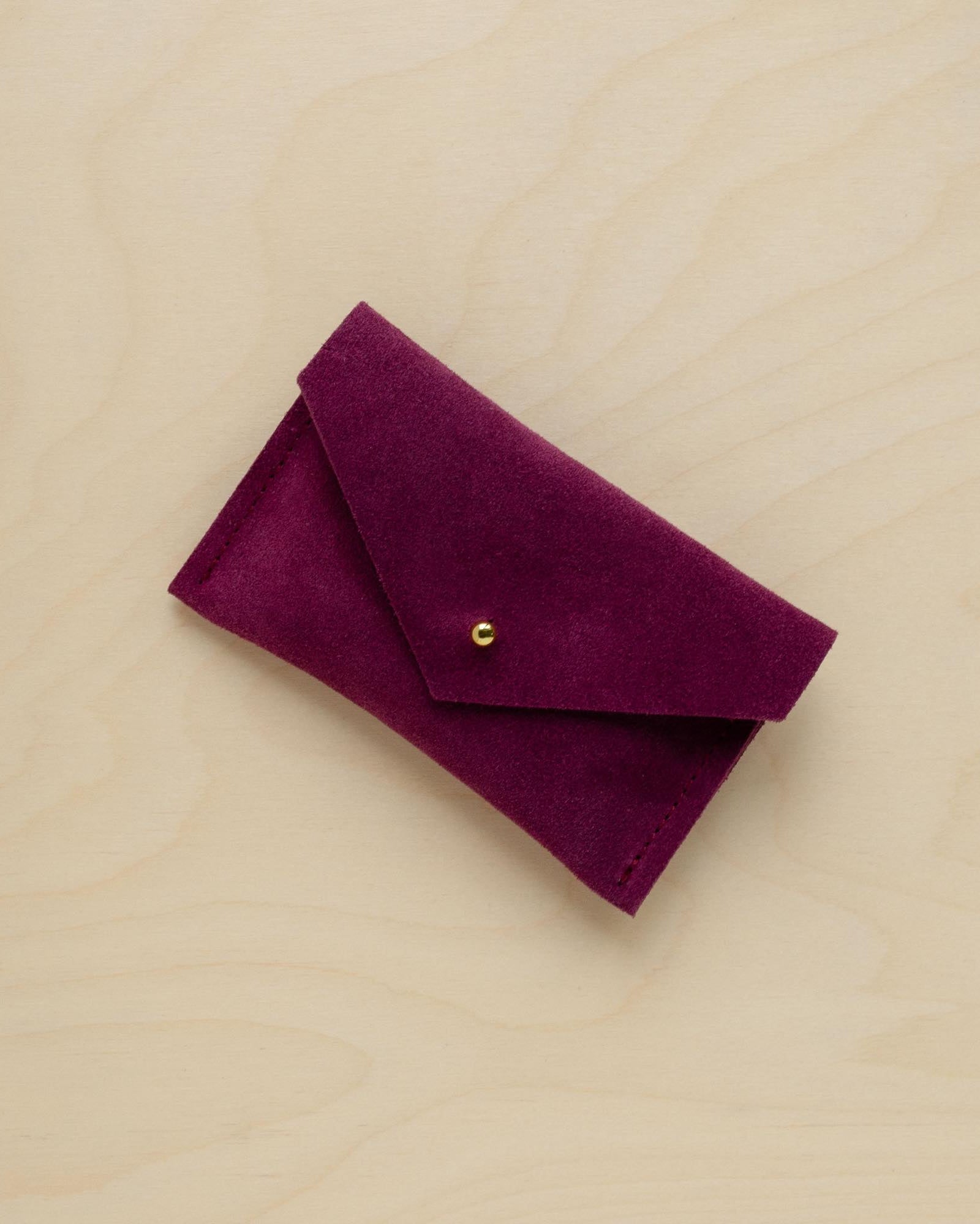 A suede Small Notions Pouch in Plum Purple. Complete with a stud for secure closing.