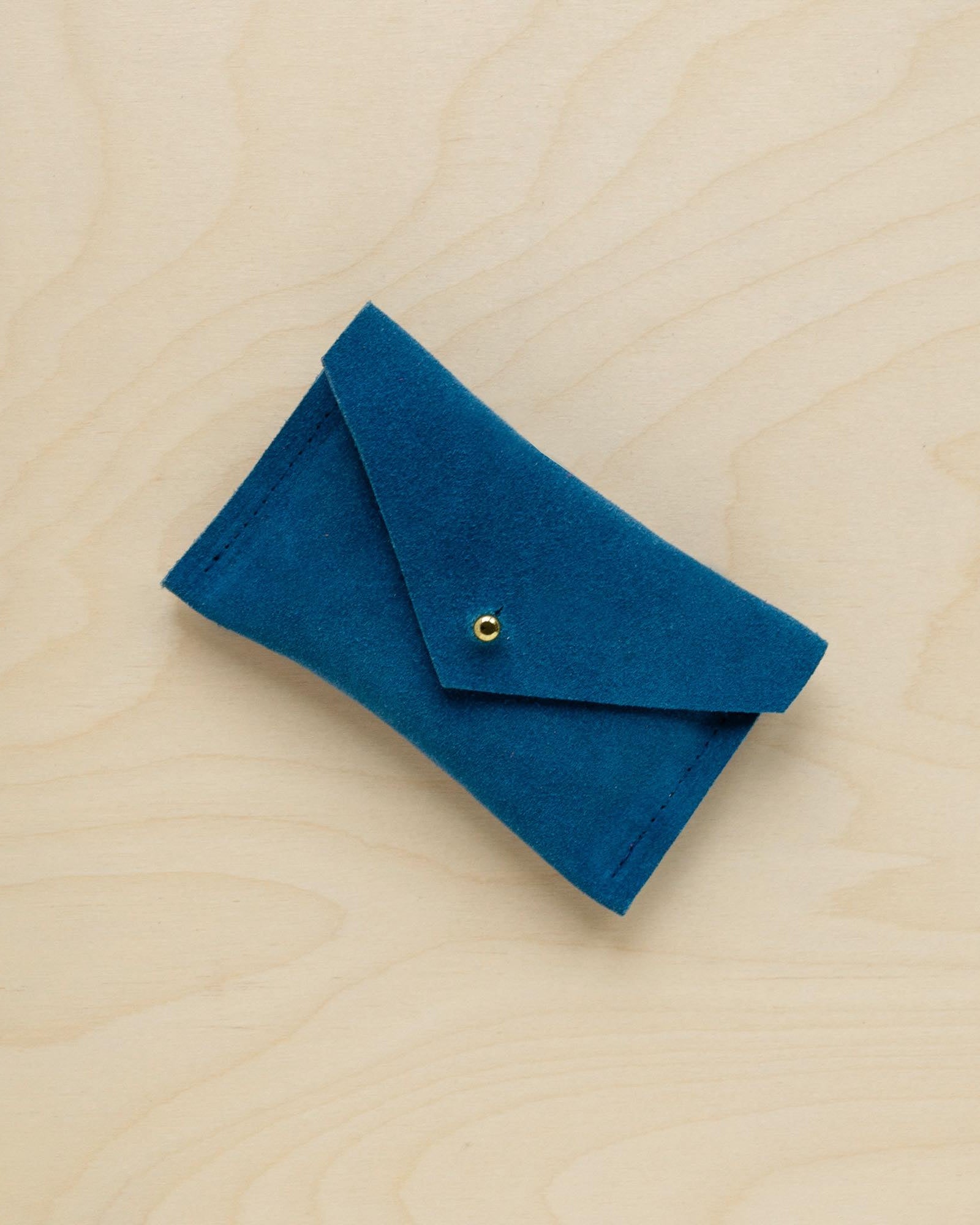 A suede Small Notions Pouch in Teal Green. Complete with a stud for secure closing.