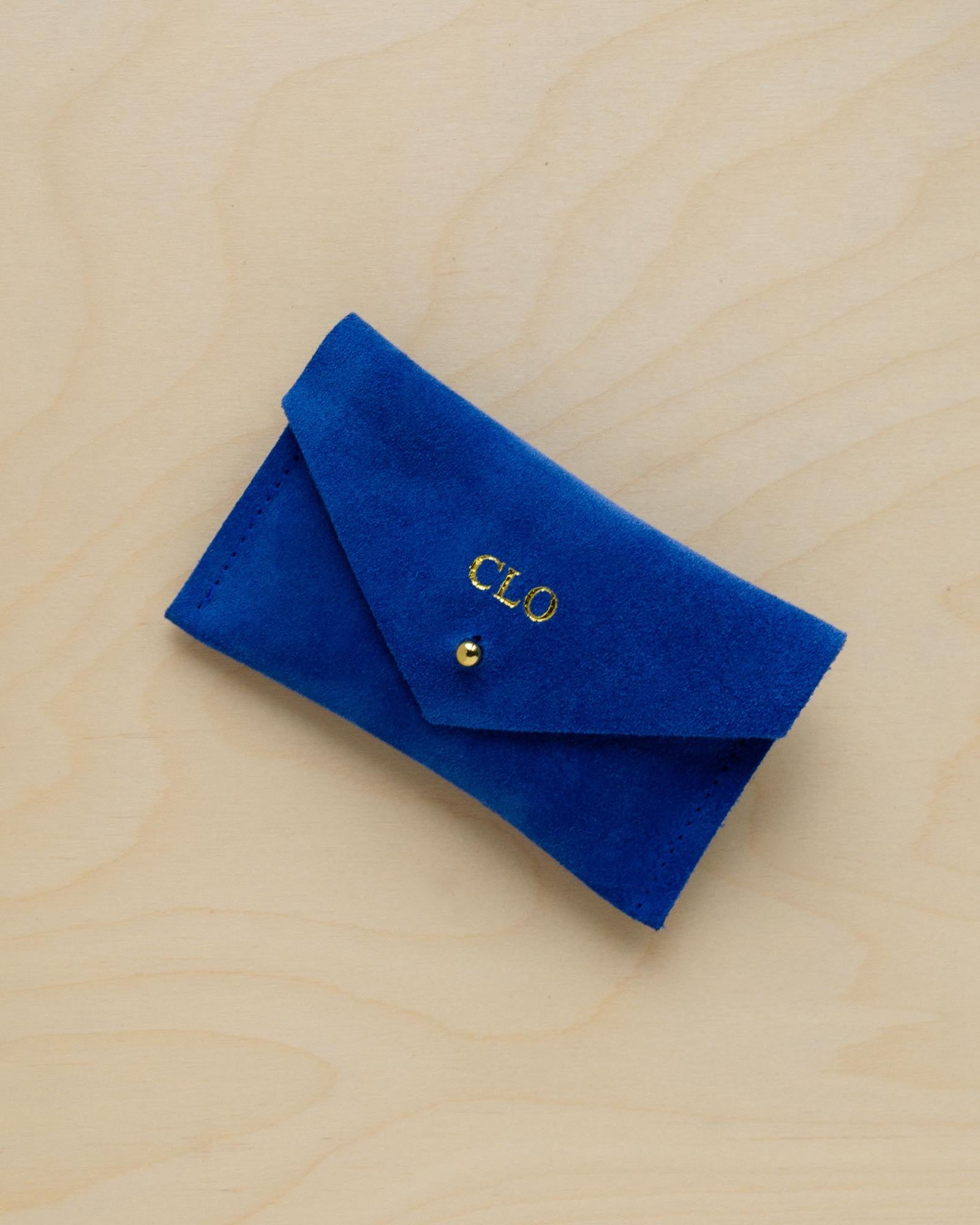 A suede Small Notions Pouch in Ultramarine Blue. Complete with a stud for secure closing. Personalised with initials.