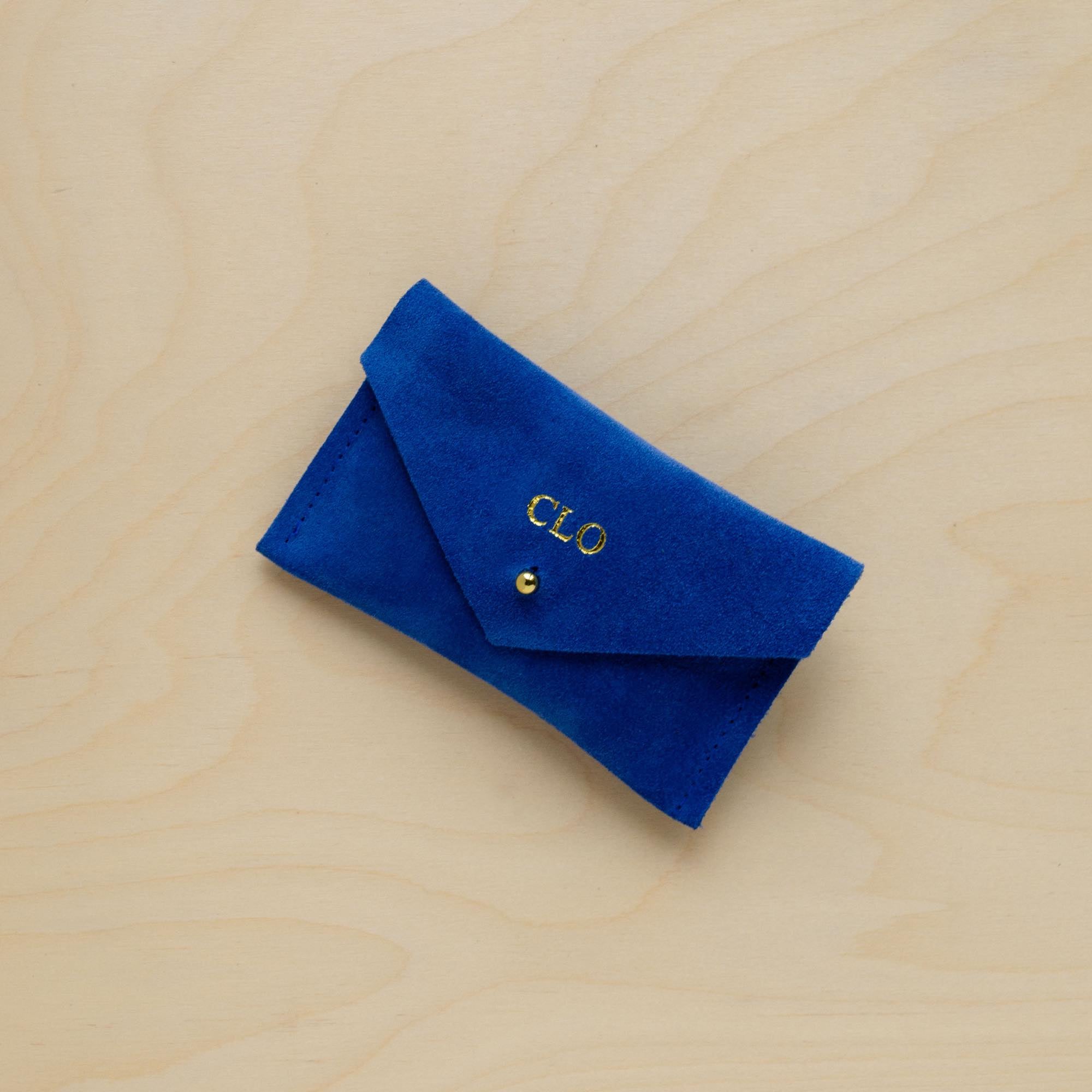 A suede Small Notions Pouch in Ultramarine Blue. Complete with a stud for secure closing. Personalised with initials.