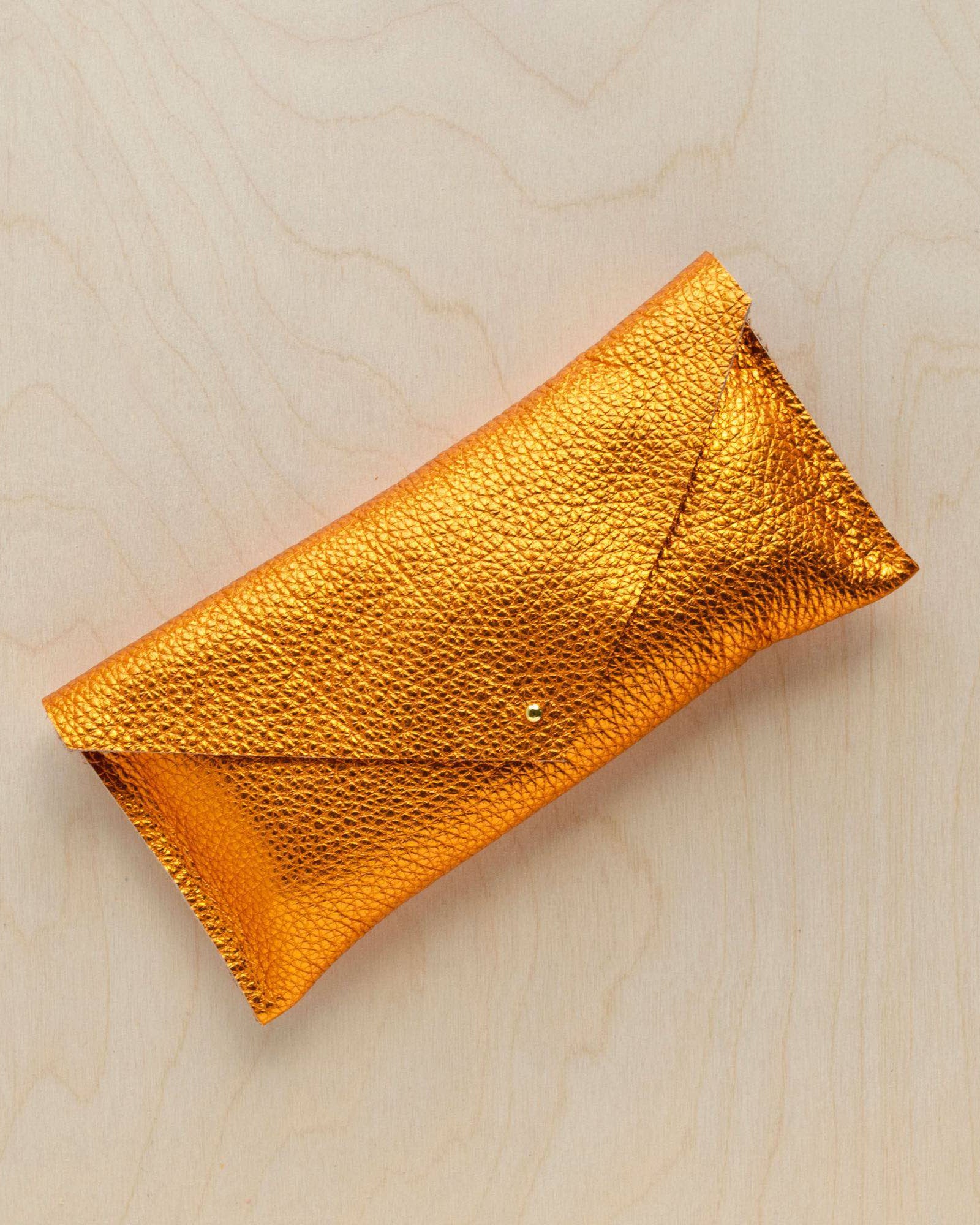 The leather clutch purse in metallic copper