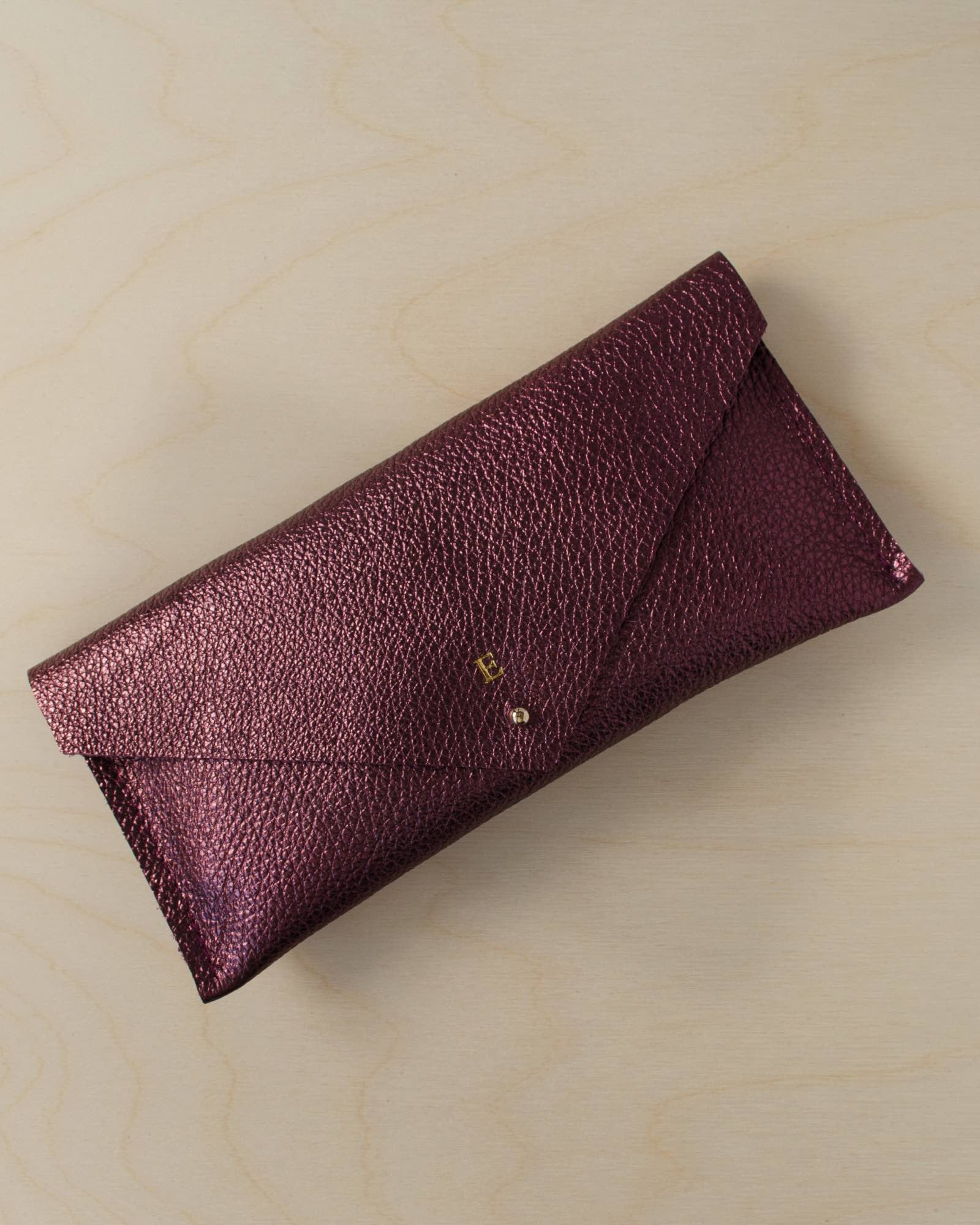 Personalised leather clutch bag in metallic berry