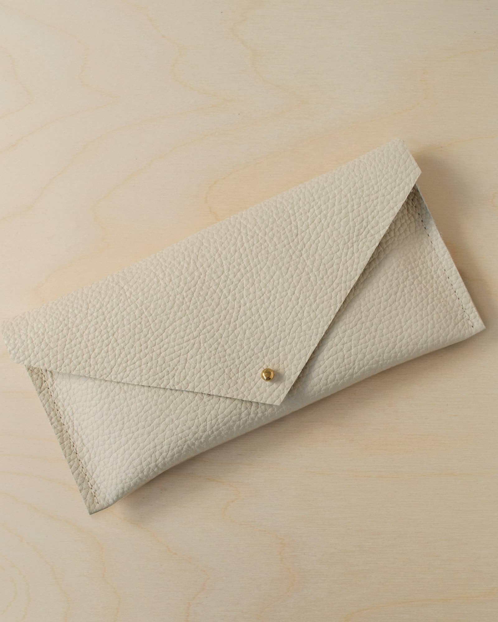 The leather clutch purse in cream
