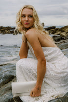Maxi Bridal Clutch Bag in a pearl, ivory, off-white colour, worn by bride on her wedding day at a beach.