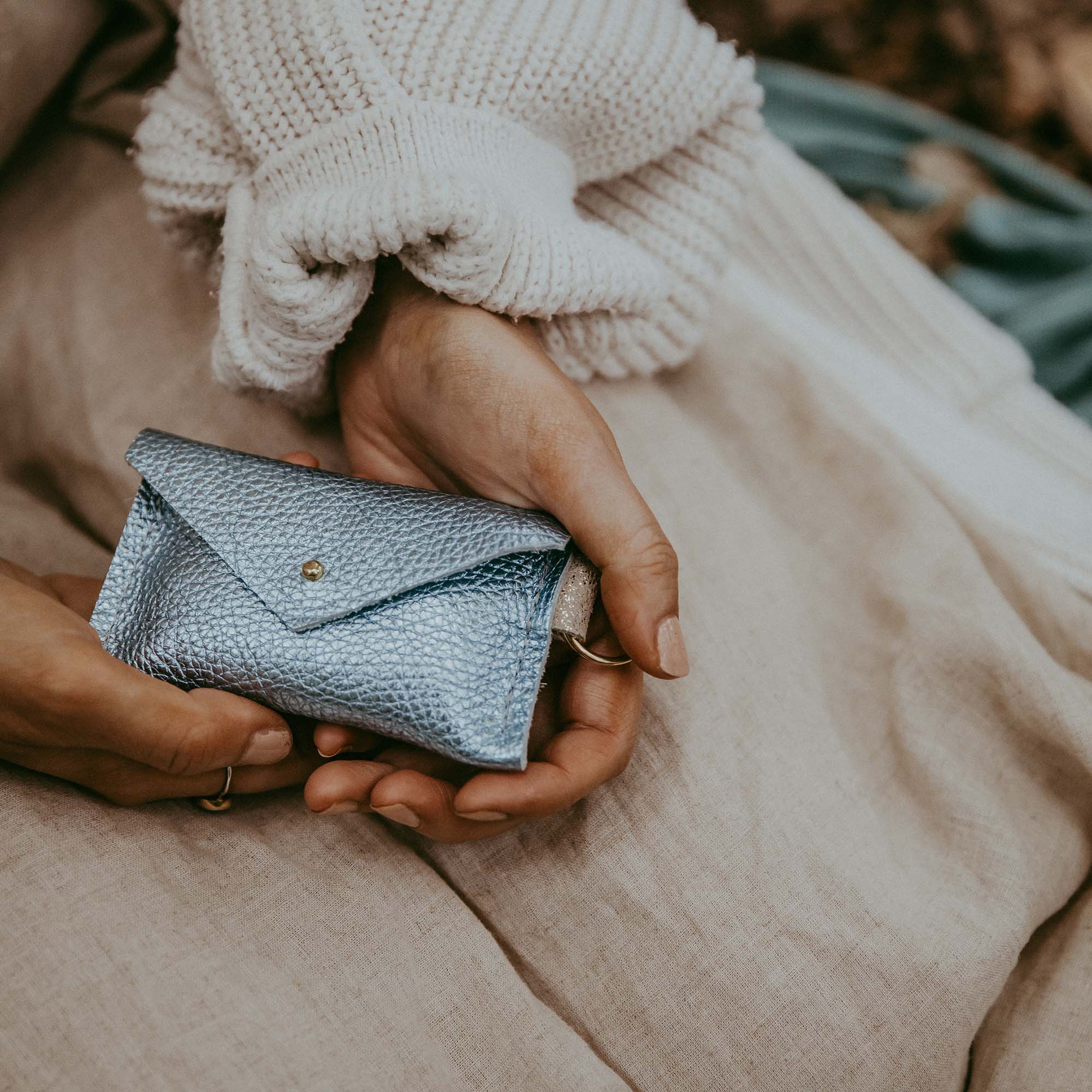 Model holding the Metallic Diamond leather keyring card holder.
