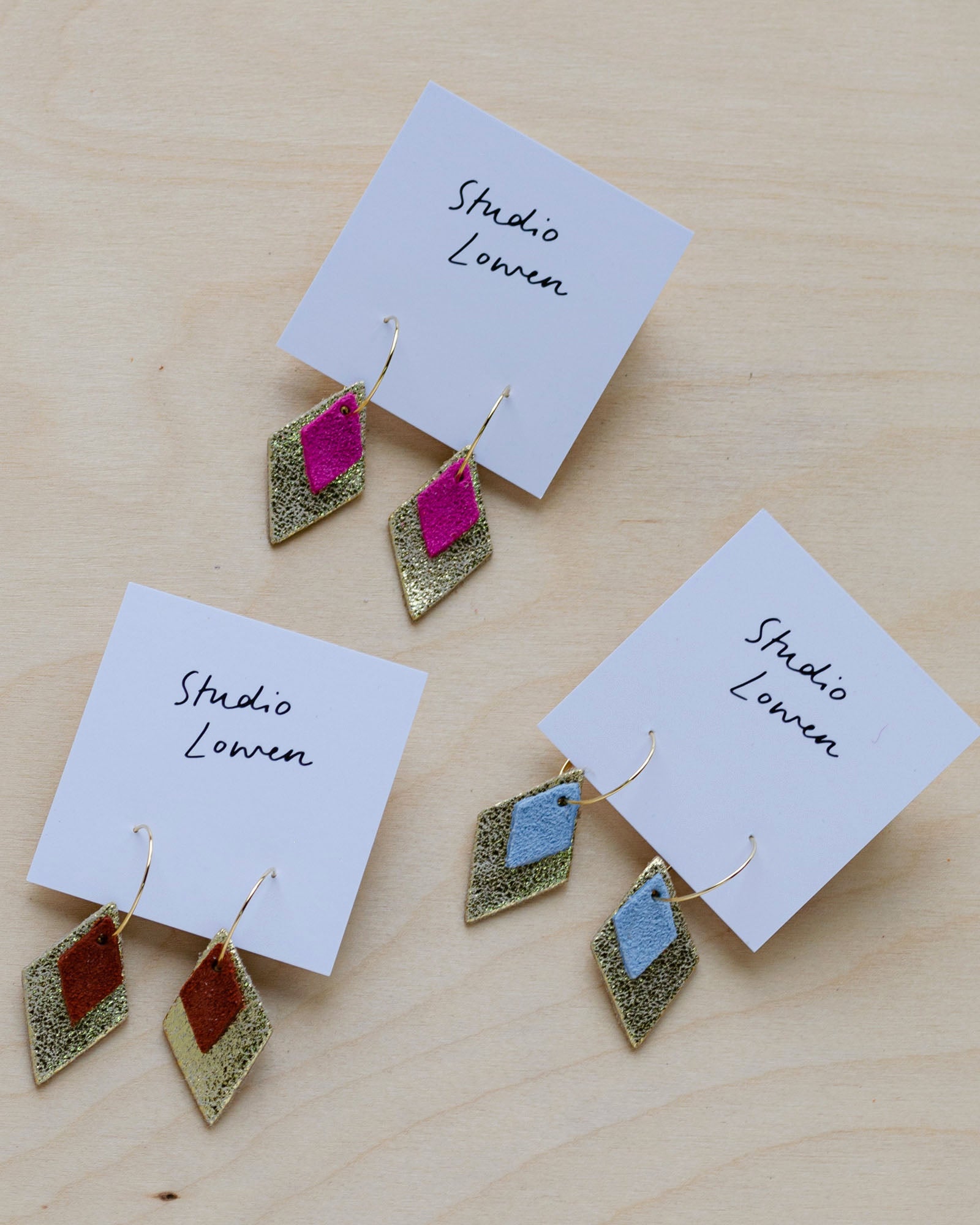 Three pairs of the Bea Hoop earrings in Fuchsia pink, Pale Blue and Chestnut Brown