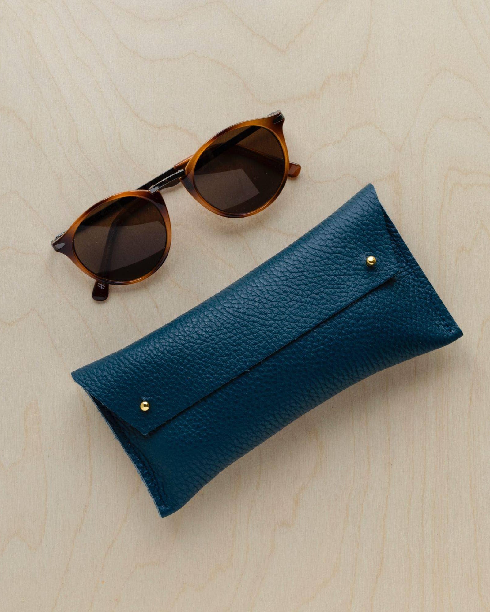 Double Stud Glasses case in Atlantic teal with sunglasses.
