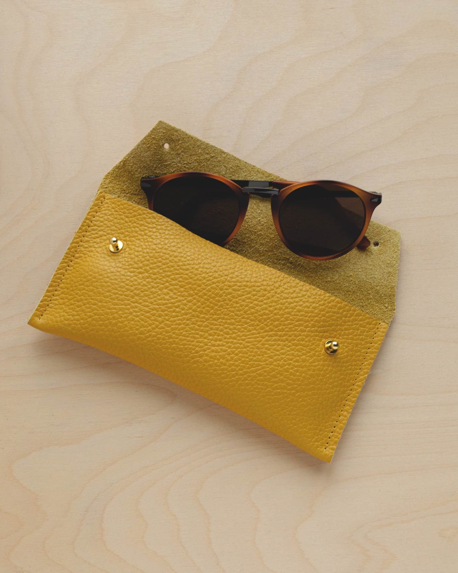 Mustard Yellow leather glasses case with sunglasses.