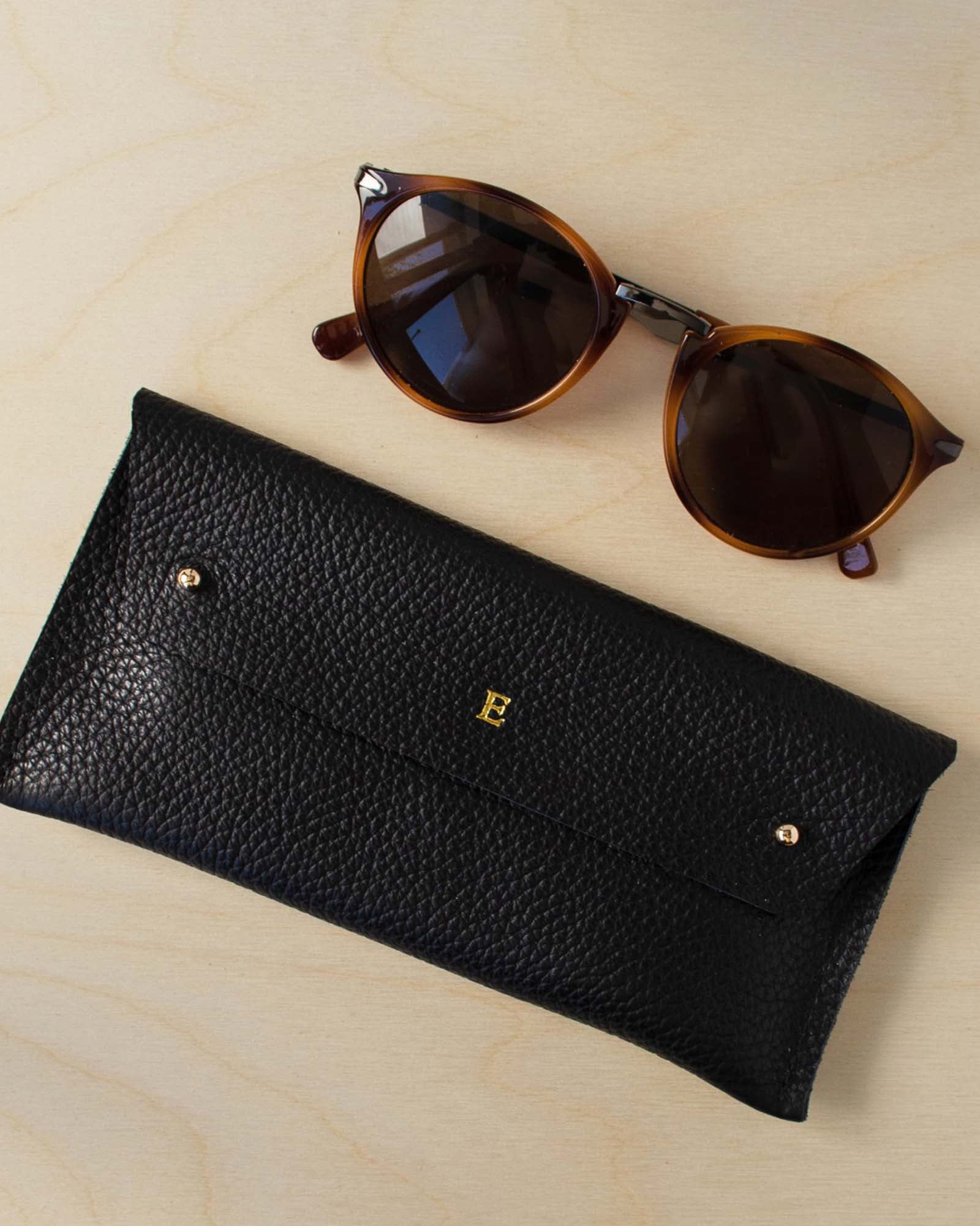 black glasses case personalised with the letter E.