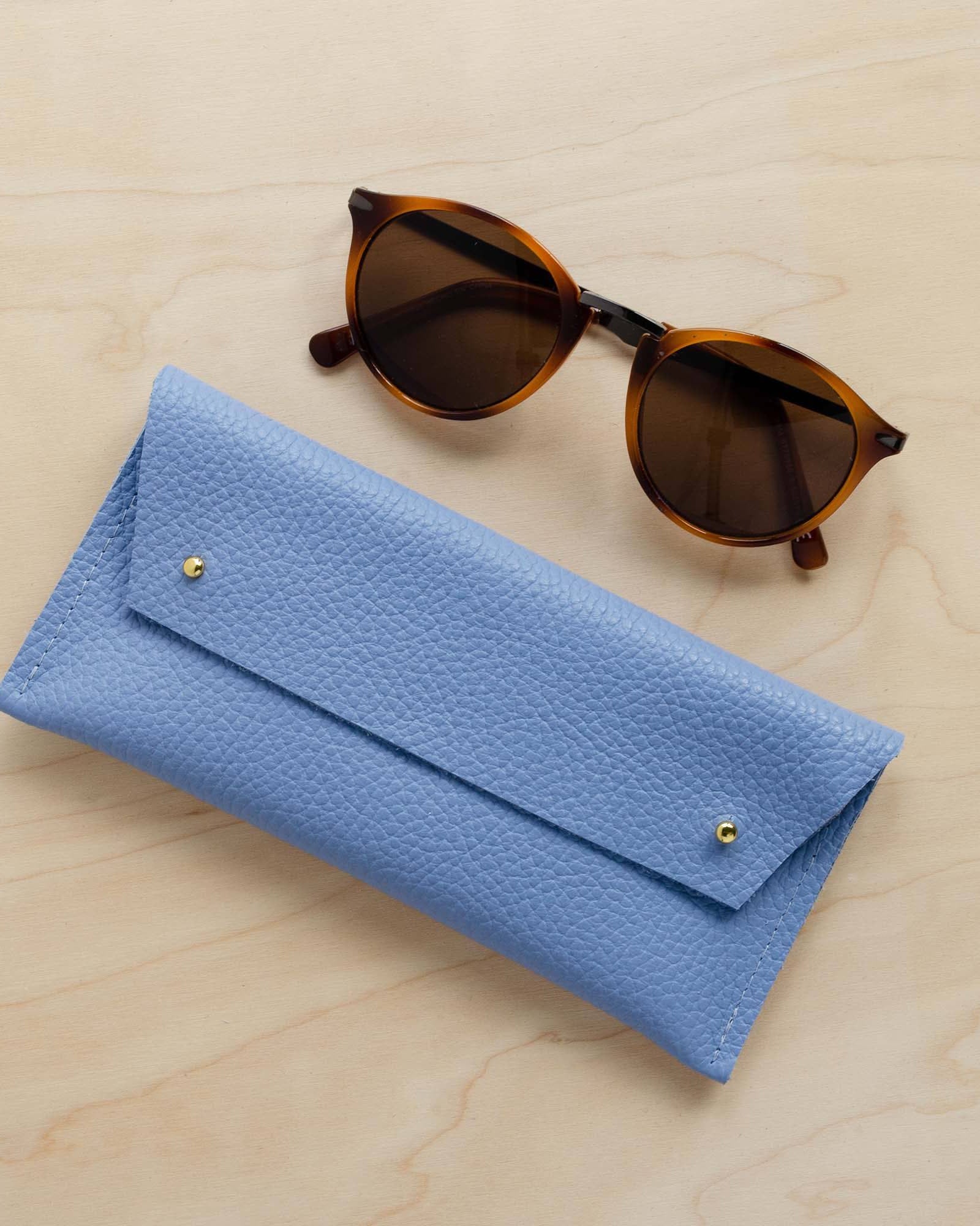 Powder Blue leather glasses case with sunglasses.
