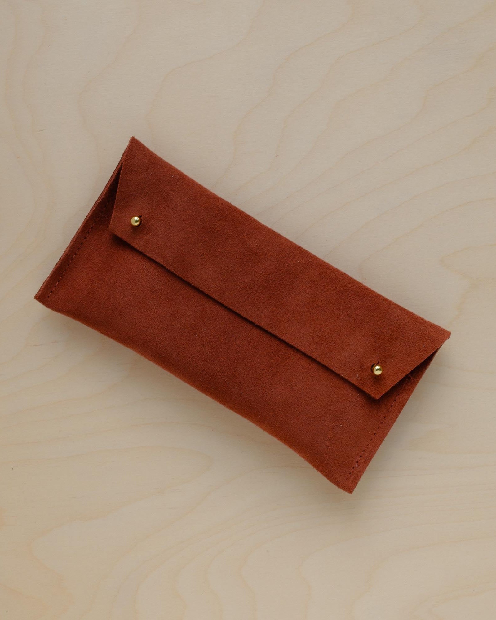 The suede pen case in Chestnut Brown. Featuring a double stud.