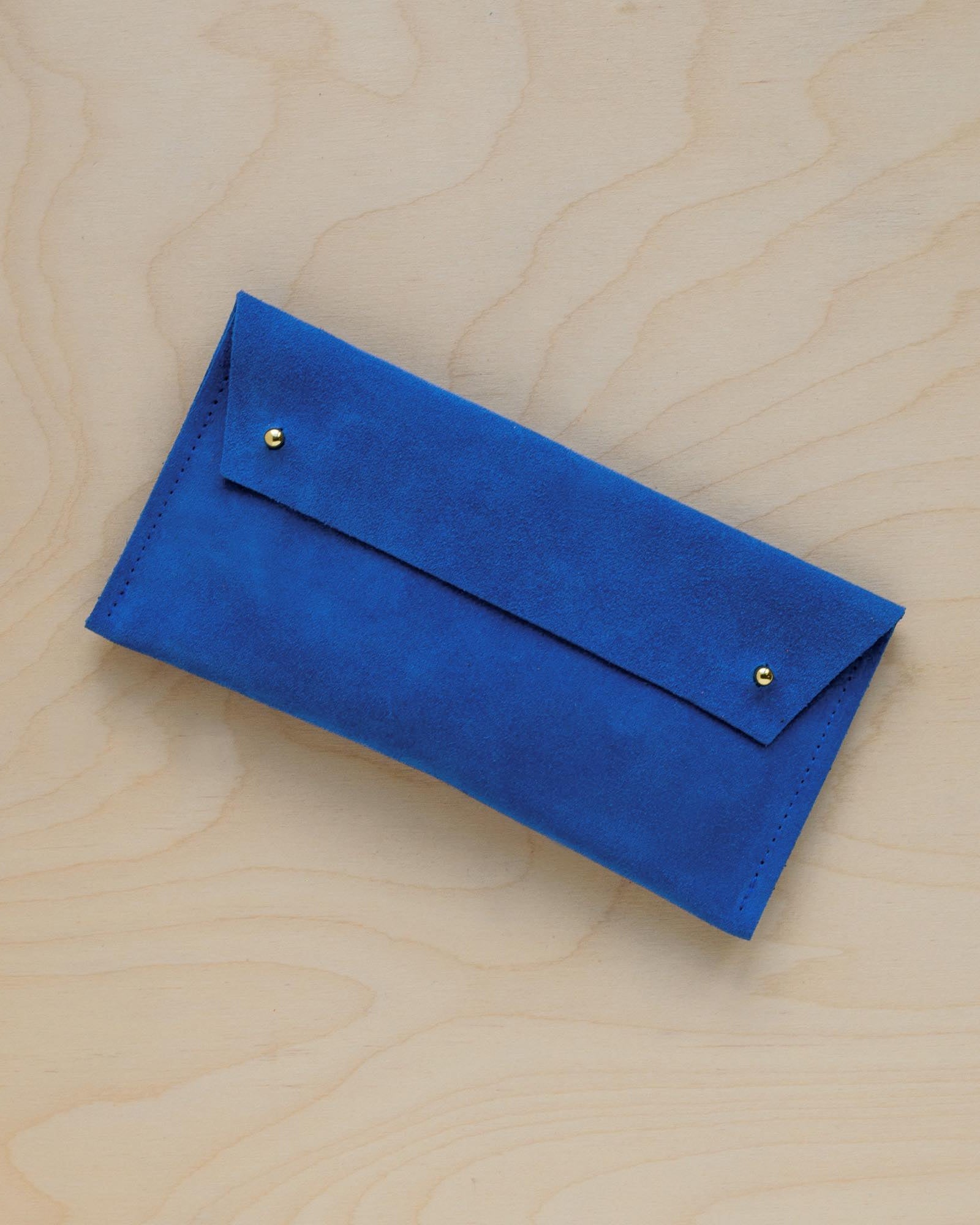 The suede pen case in Cobalt Blue. Featuring a double stud.