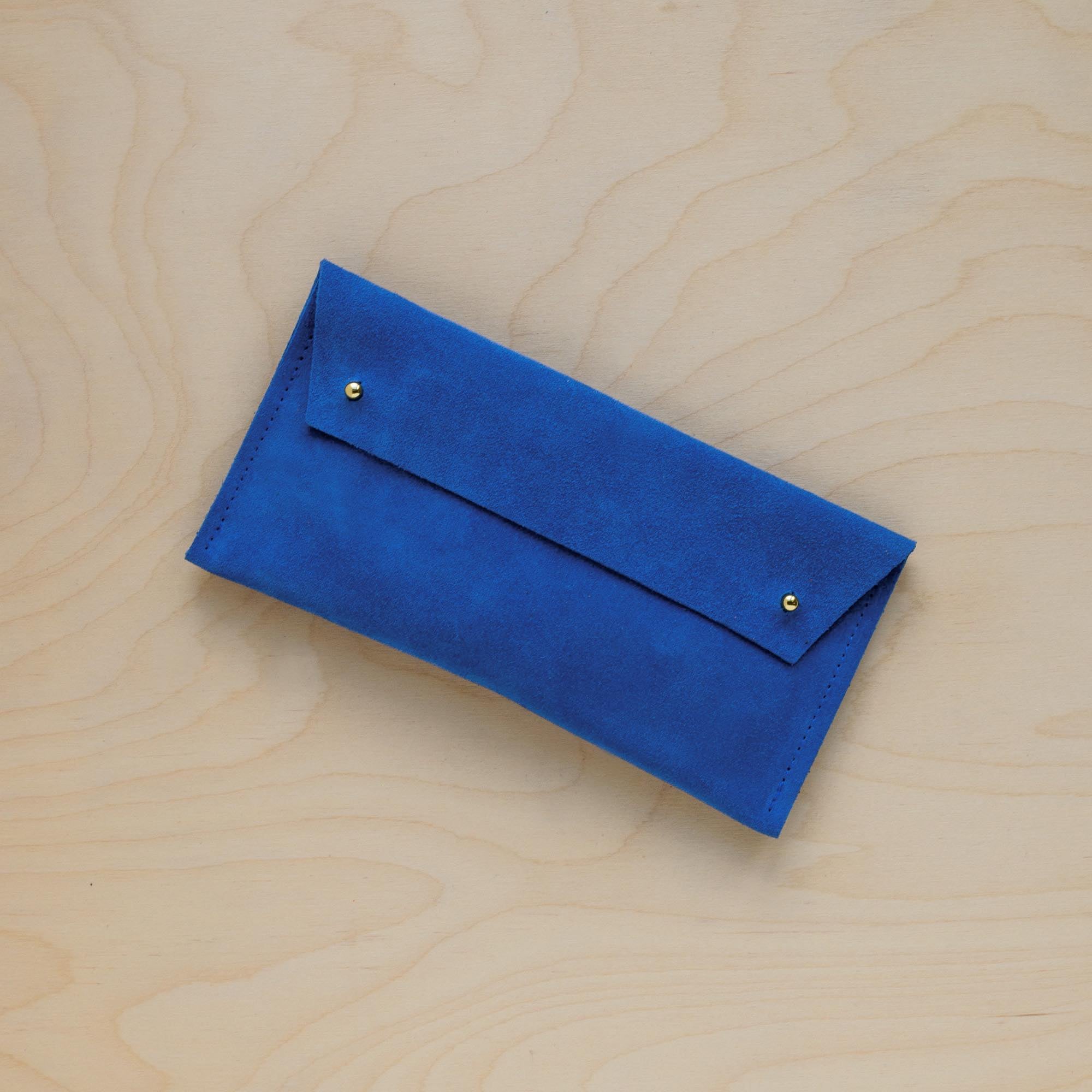 The suede pen case in Cobalt Blue. Featuring a double stud.