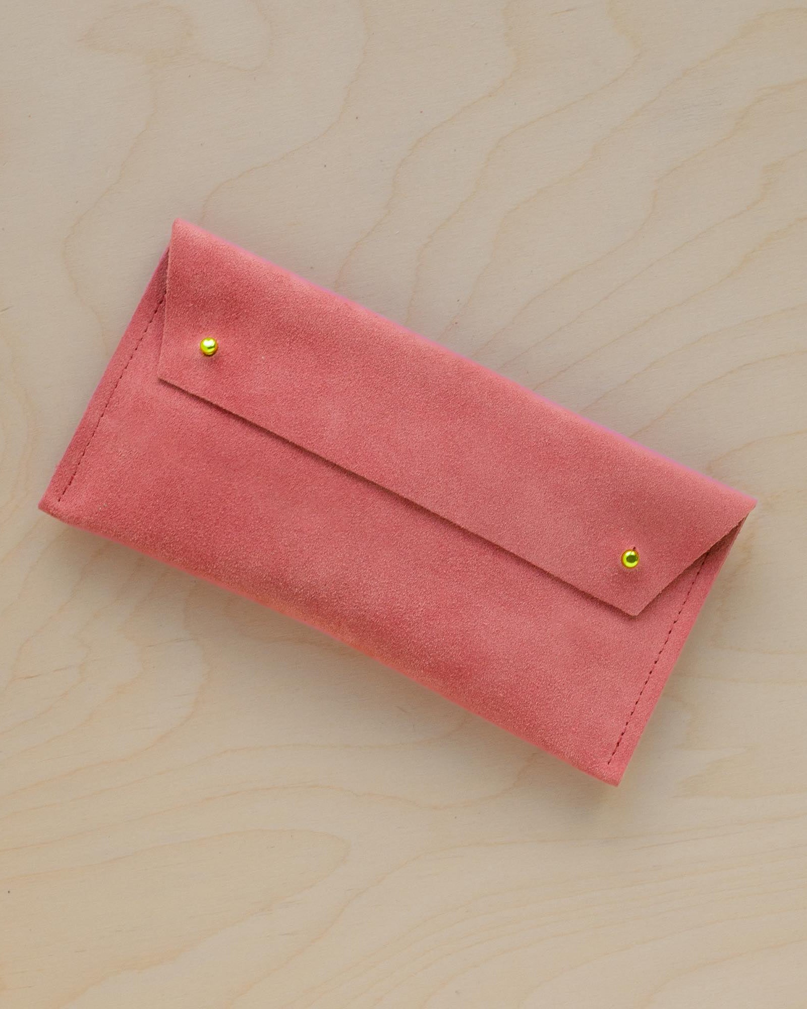 The suede pen case in Coral Pink. Featuring a double stud.