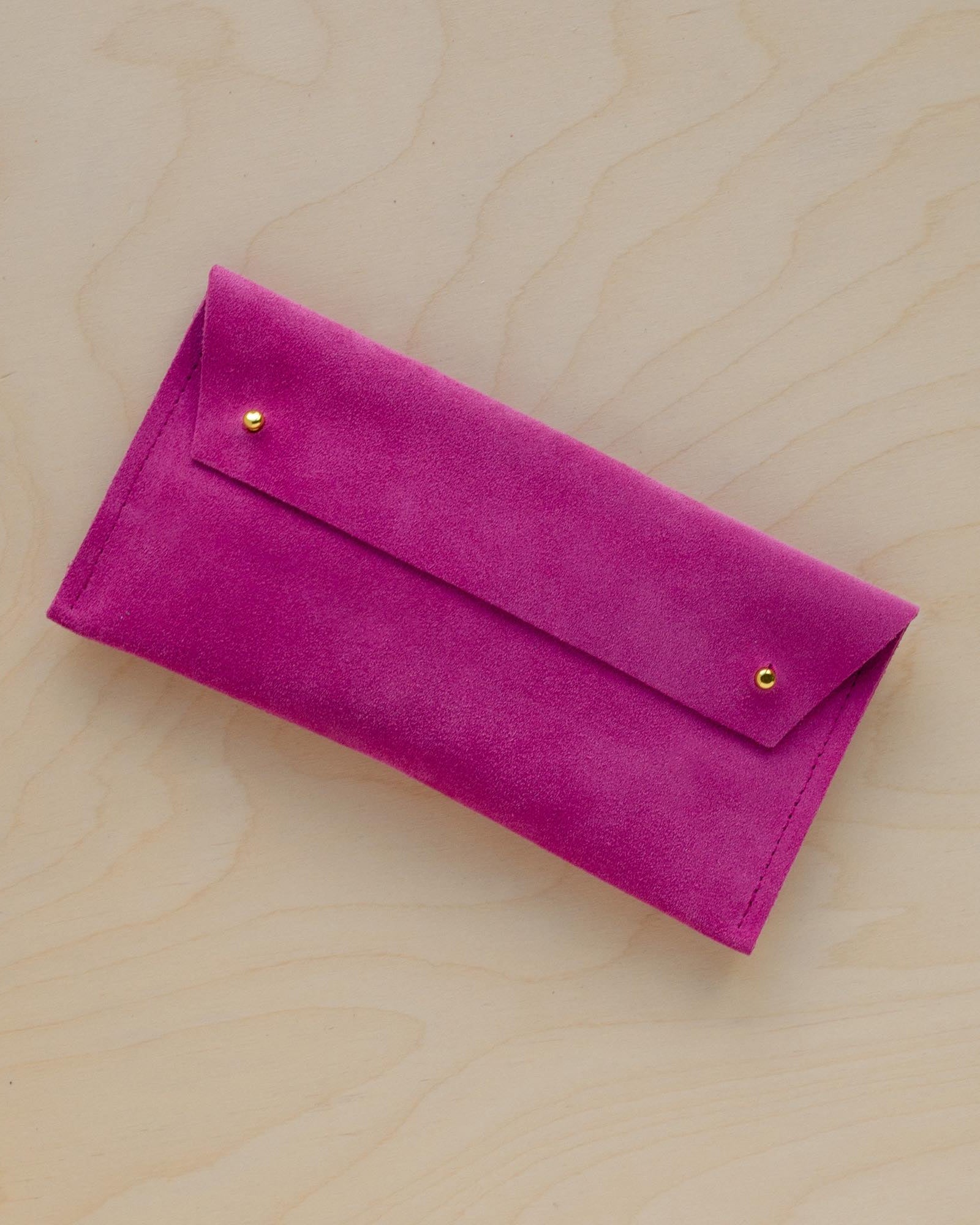The suede pen case in Fuchsia Pink. Featuring a double stud.