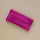 The suede pen case in Fuchsia Pink. Featuring a double stud.