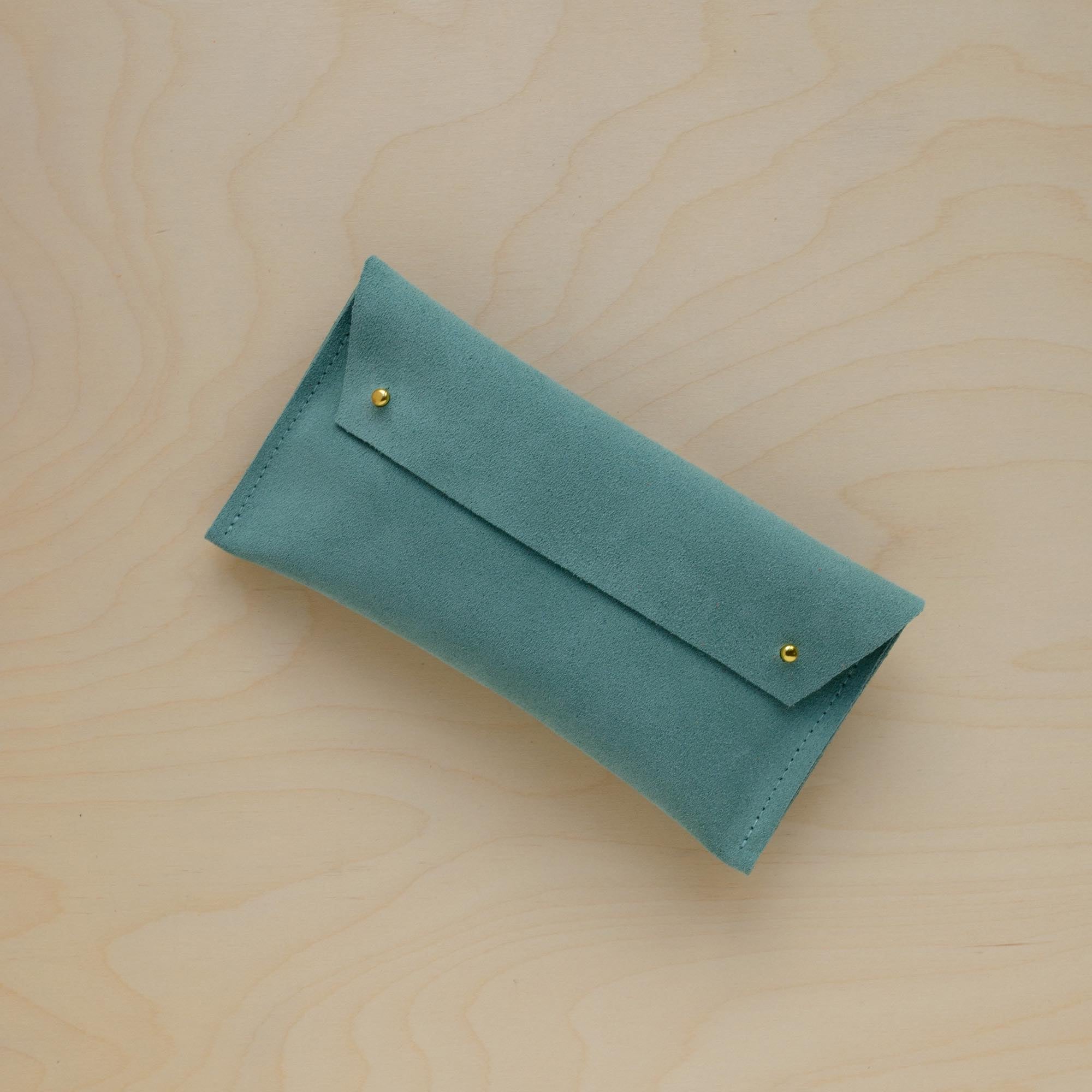The suede pen case in Mint Green. Featuring a double stud.