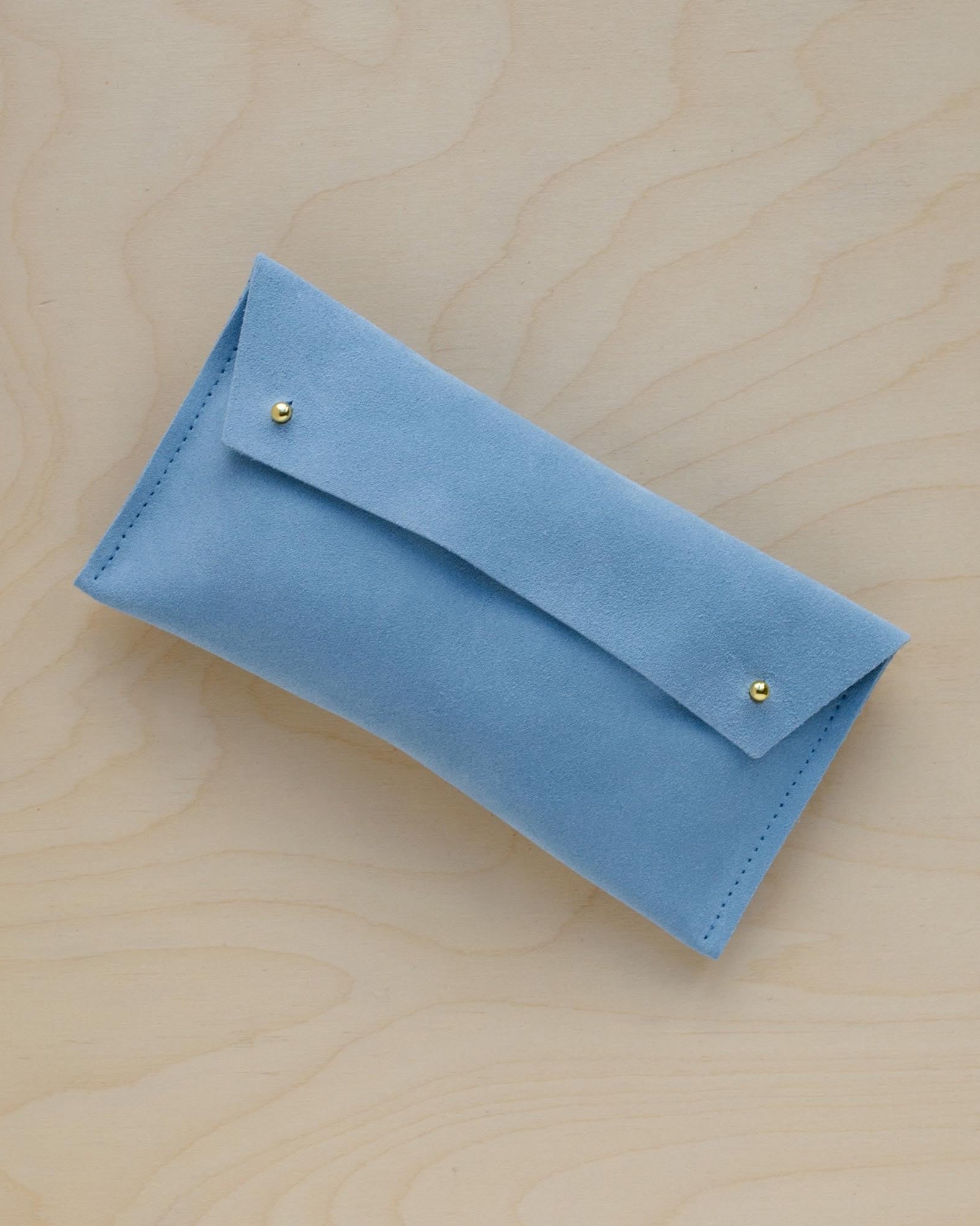 The suede pen case in Pale Blue. Featuring a double stud.