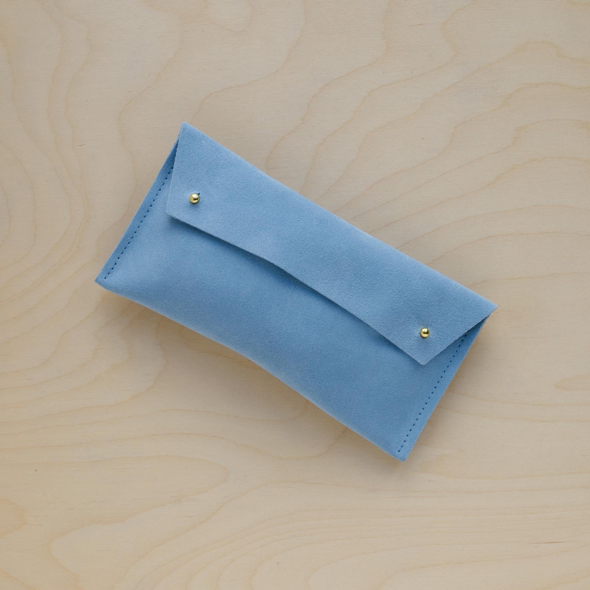 The suede pen case in Pale Blue. Featuring a double stud.
