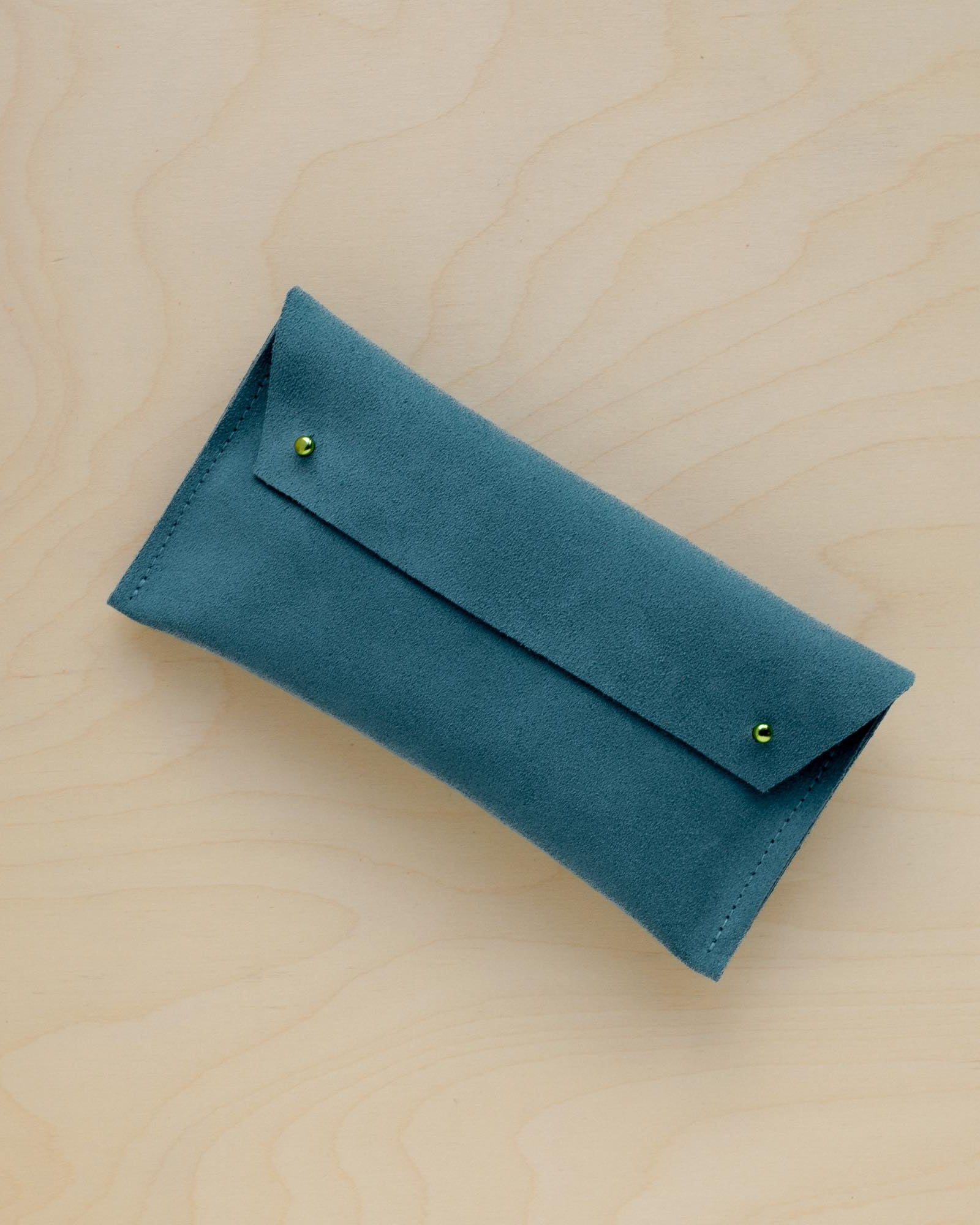 The suede pen case in Teal. Featuring a double stud.