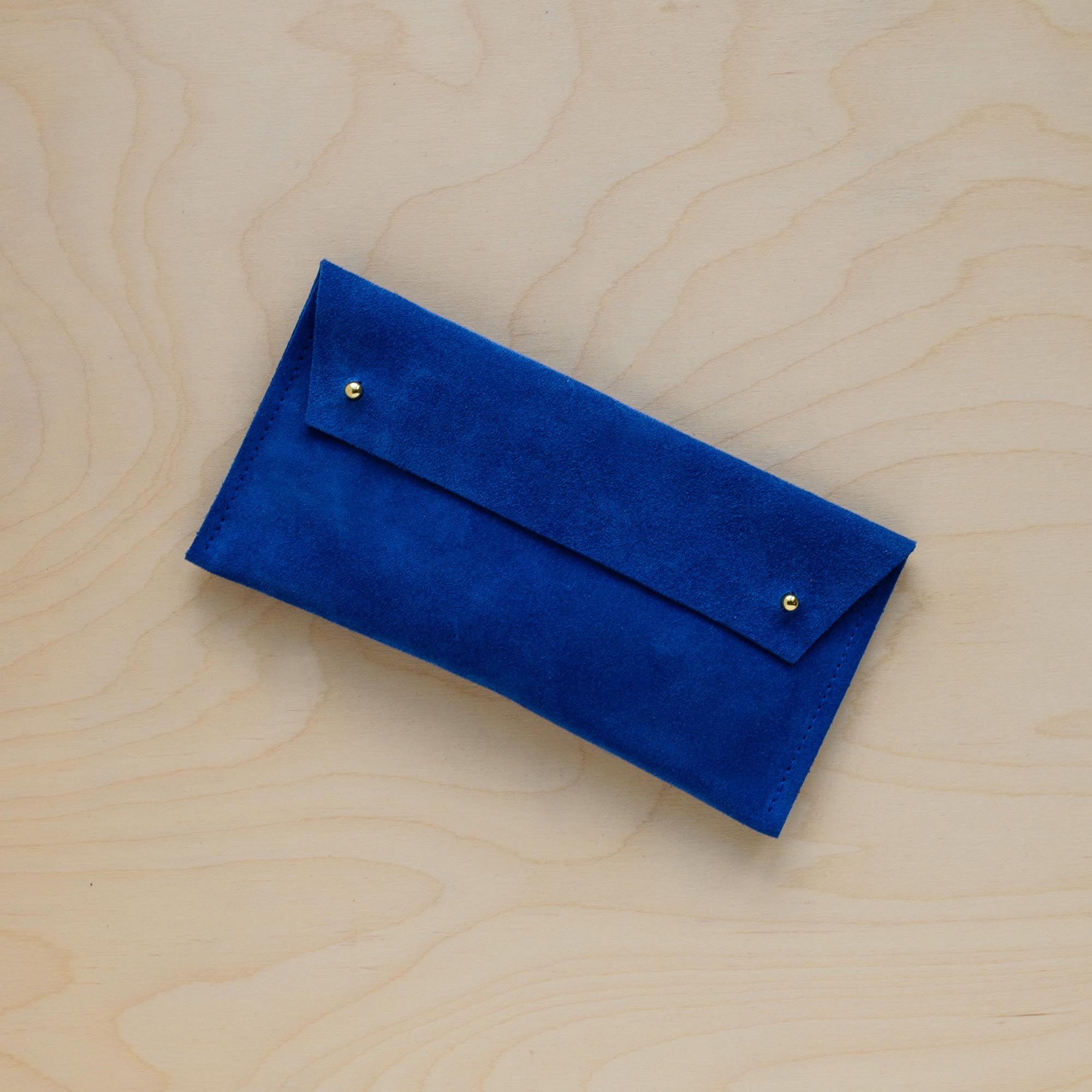 The suede pen case in Ultramarine Blue. Featuring a double stud.