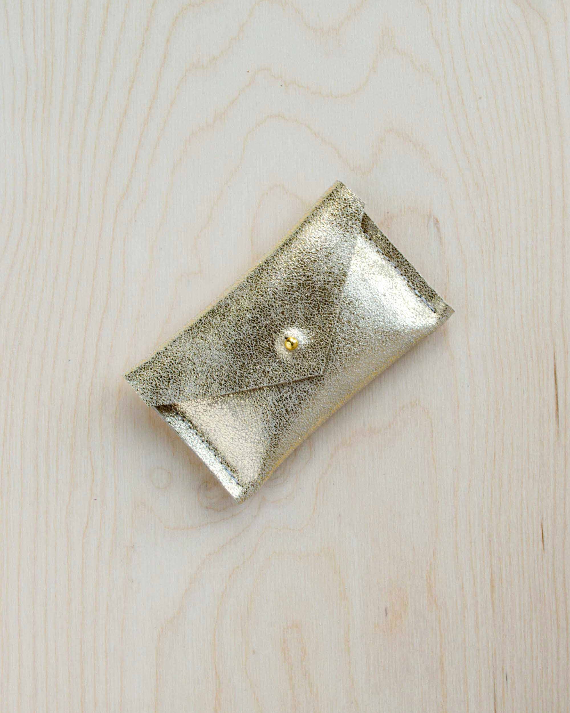 Gold leather wallet on a wooden background