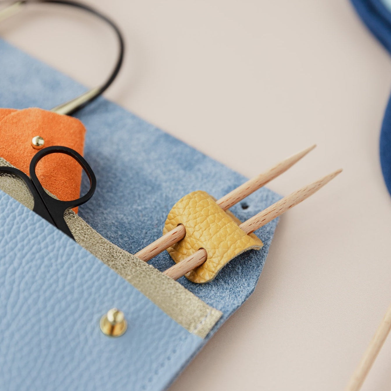 Knitting needle holder and notions pouch