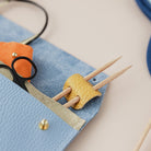 Knitting needle holder and notions pouch