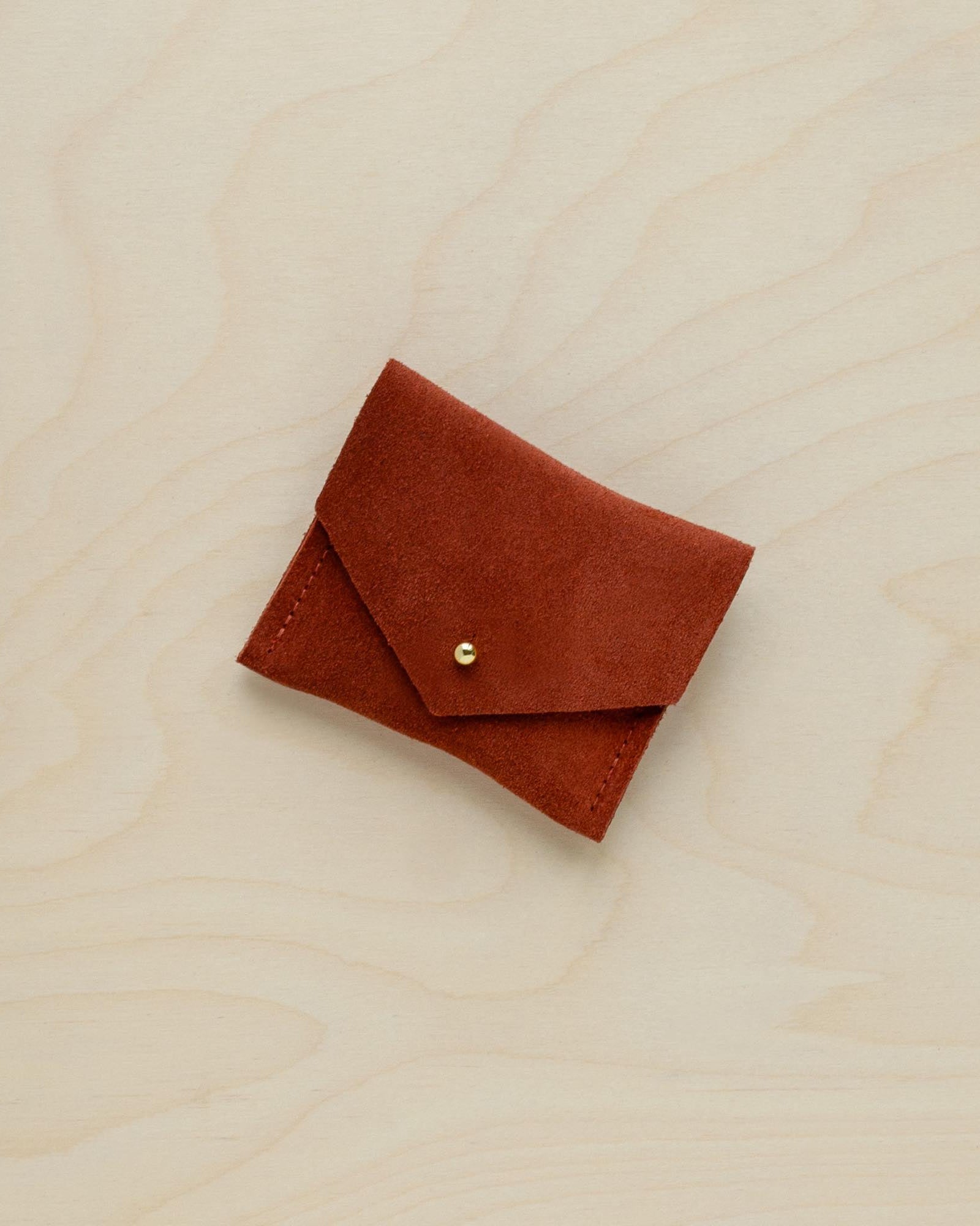 A suede Stitch Markers pouch in Chestnut brown. Complete with a stud for secure closing.