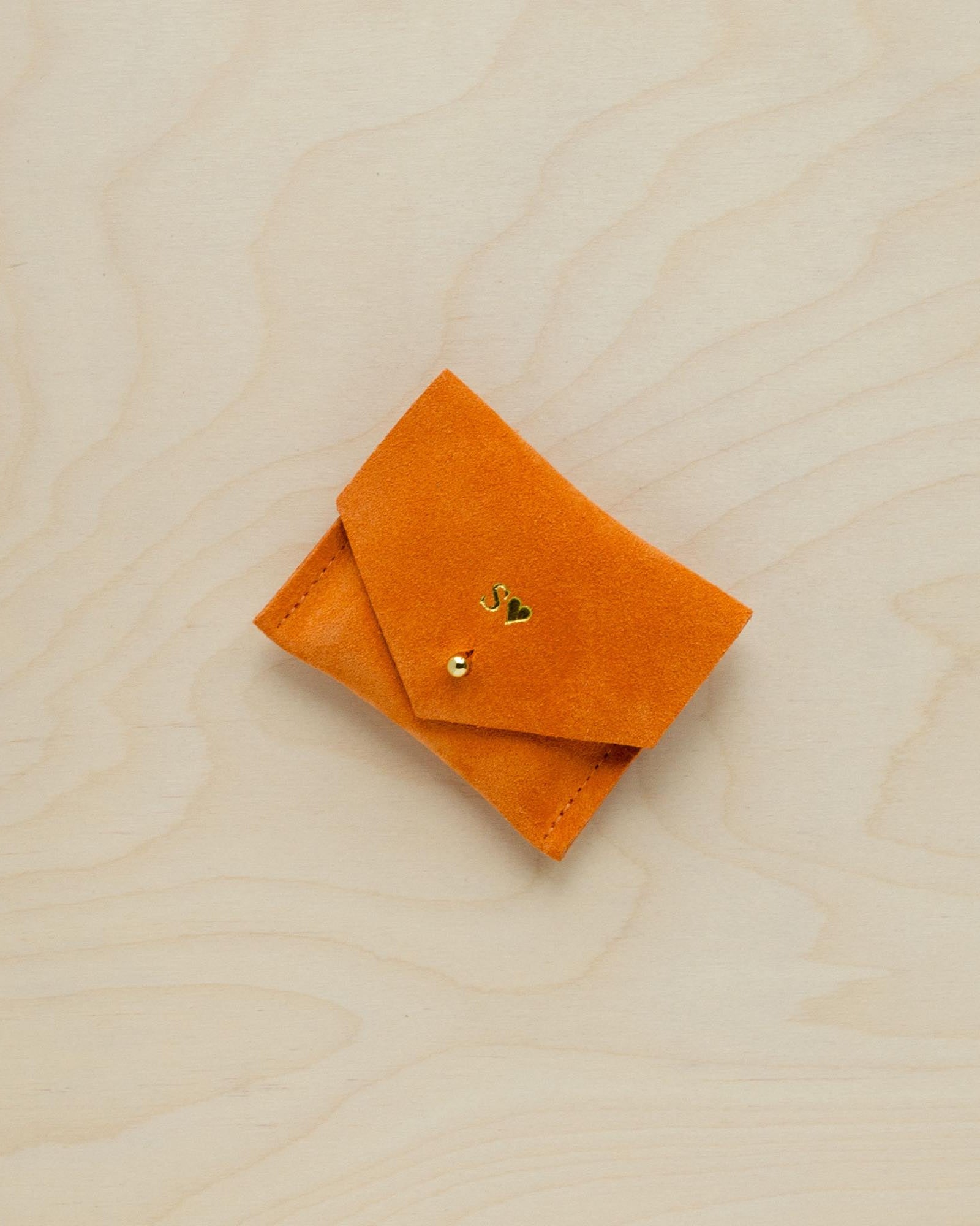 A suede Stitch Markers pouch in clementine orange. Complete with a stud for secure closing. This pouch has been personalised.