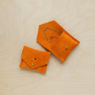 A suede Stitch Markers pouch in Clementine Orange. Complete with a stud for secure closing. This pouch has been personalised.