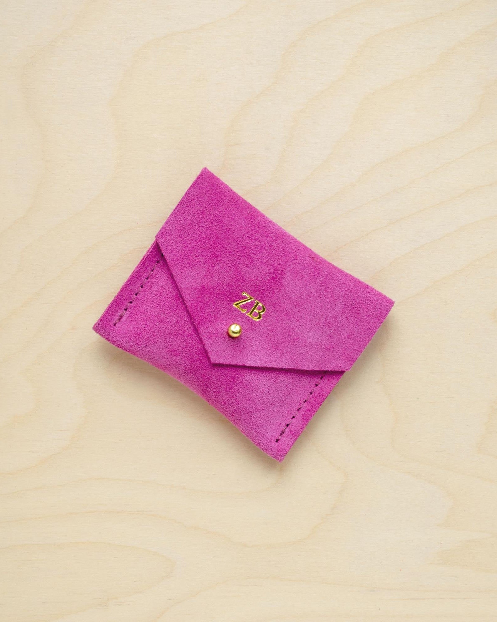 A suede Stitch Markers pouch in Fuchsia Pink. Complete with a stud for secure closing. This pouch has been personalised with initials.