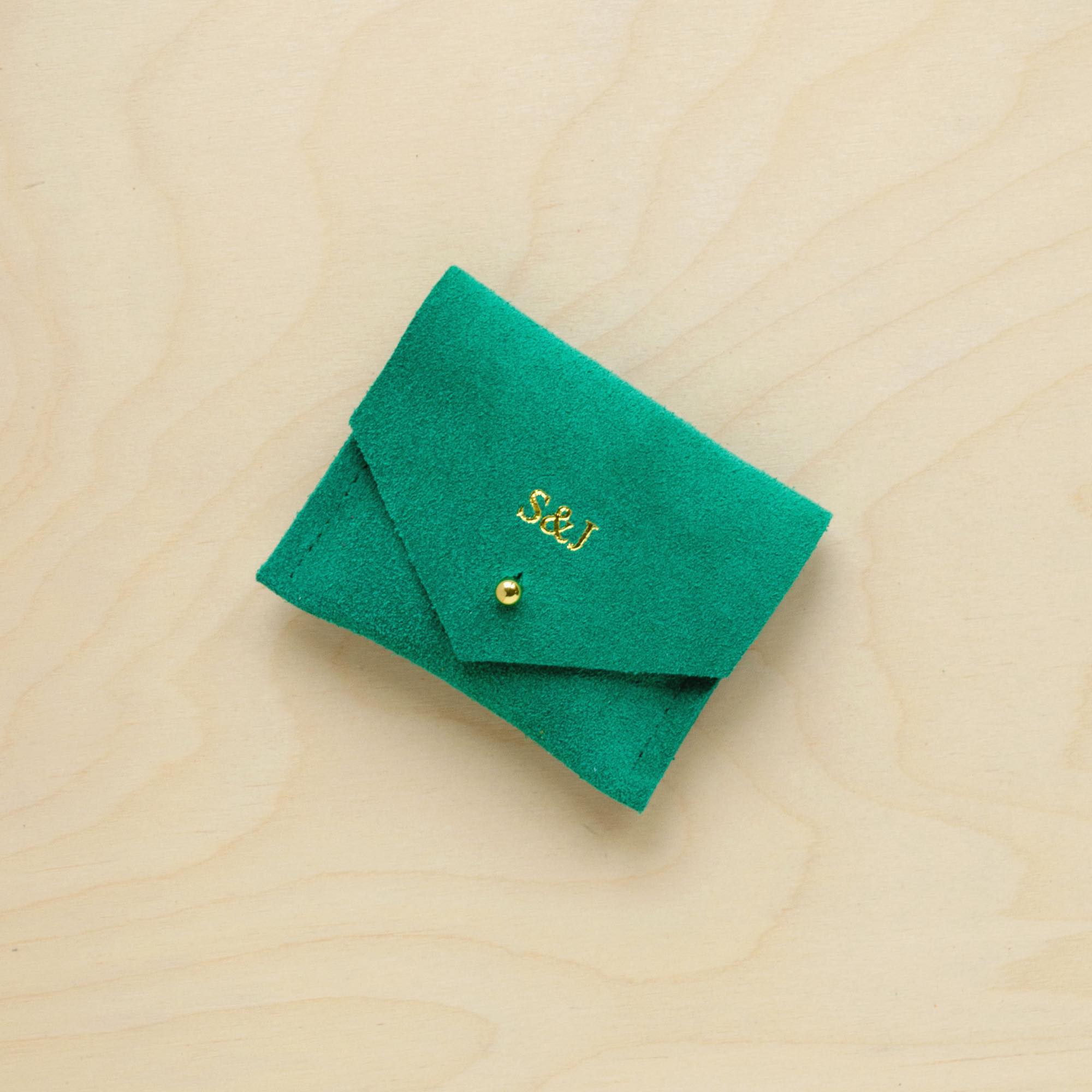 A suede Stitch Markers pouch in Jade Green. Complete with a stud for secure closing. This pouch has been personalised with couple initials.
