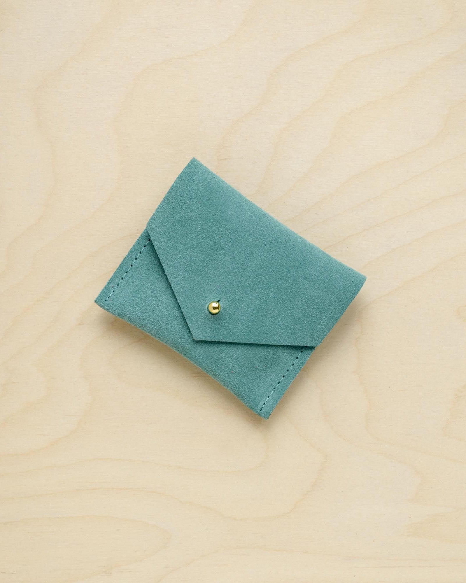 A suede Stitch Markers pouch in Mint Green. Complete with a stud for secure closing.