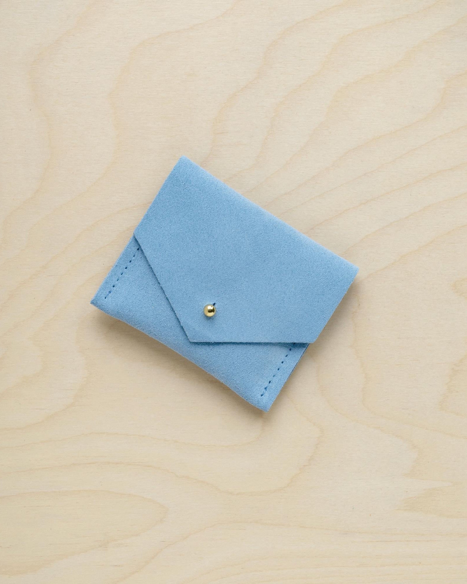 A suede Stitch Markers pouch in Pale Blue. Complete with a stud for secure closing.