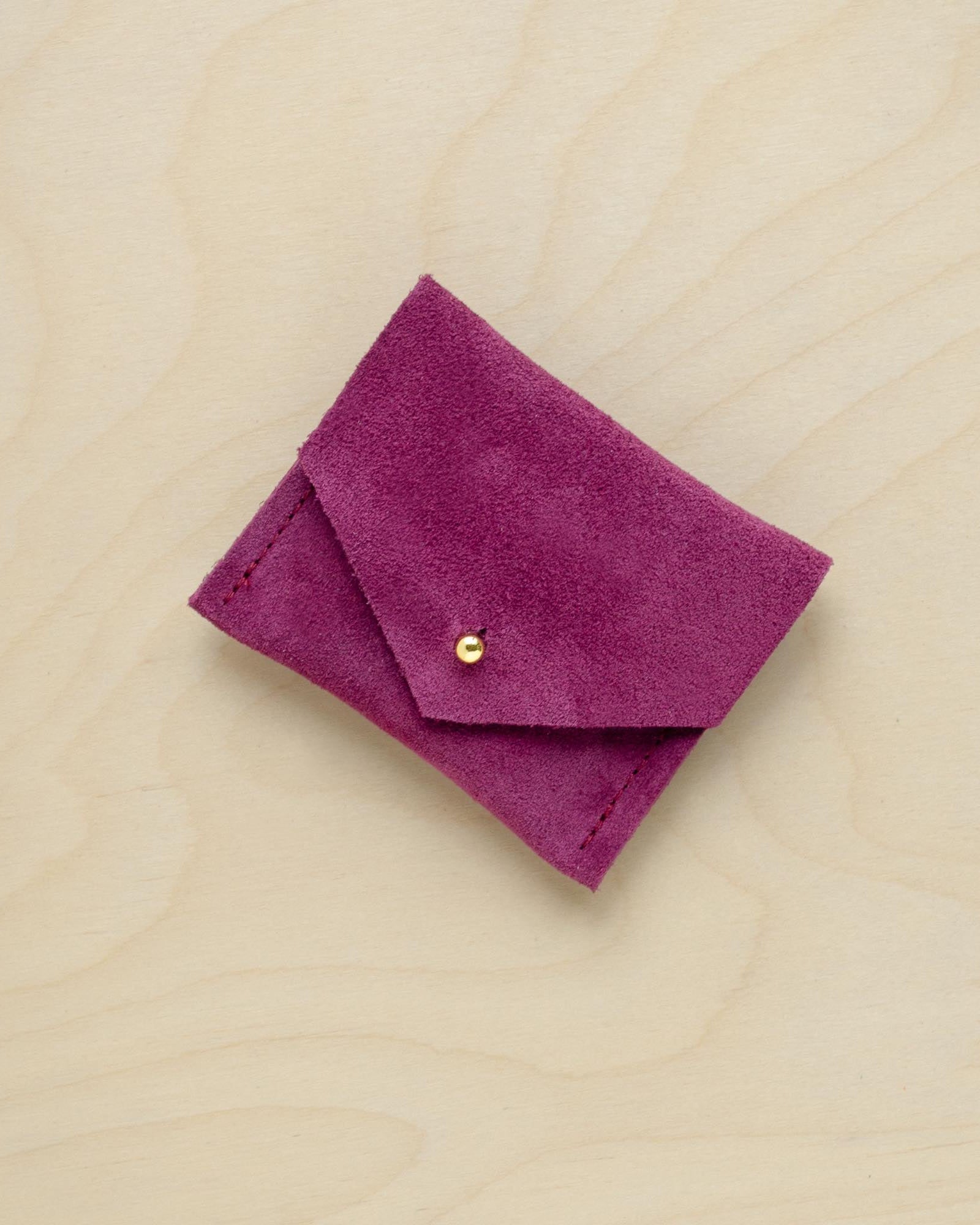 A suede Stitch Markers pouch in Plum Purple. Complete with a stud for secure closing.