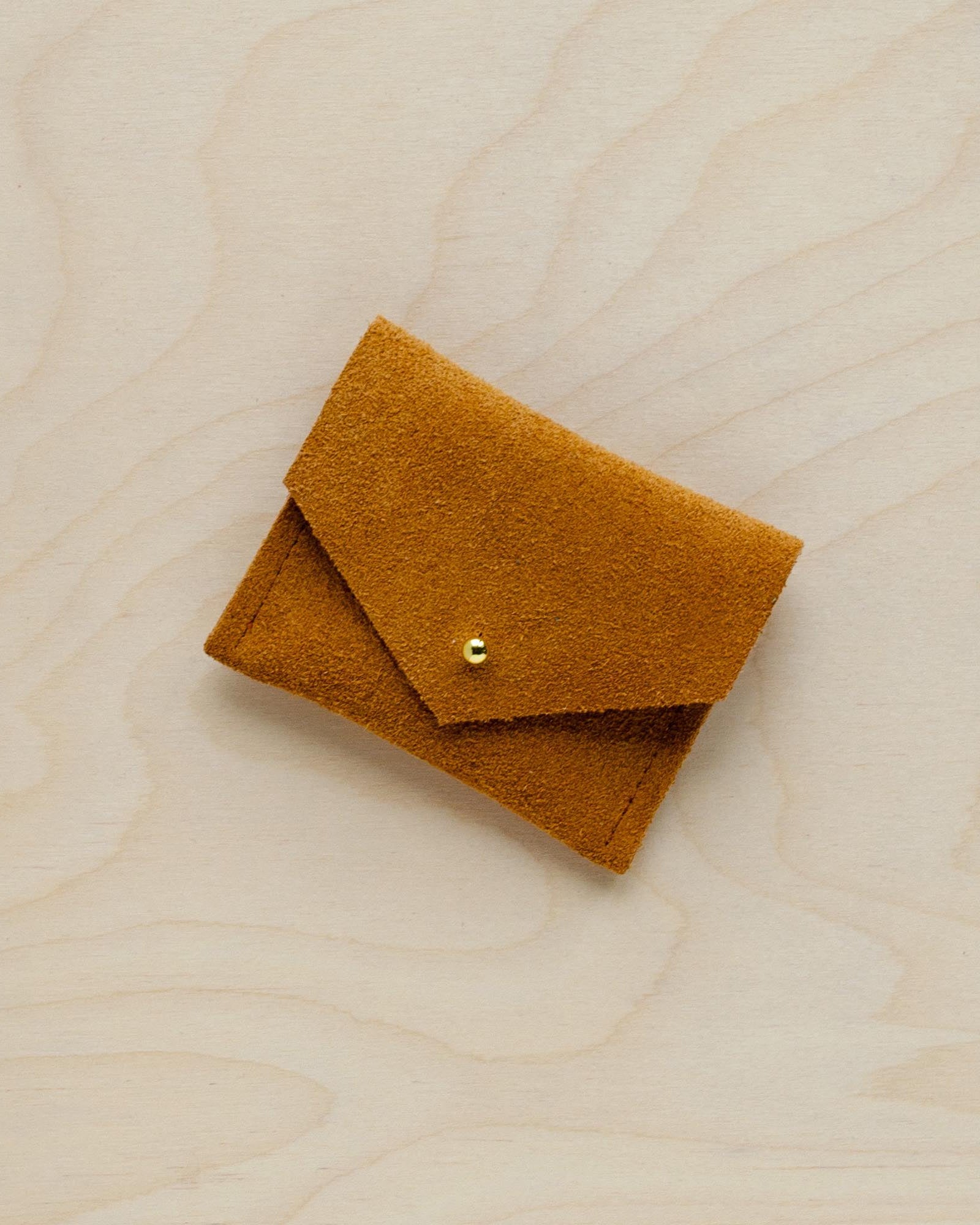 A suede Stitch Markers pouch in Tan brown. Complete with a stud for secure closing.