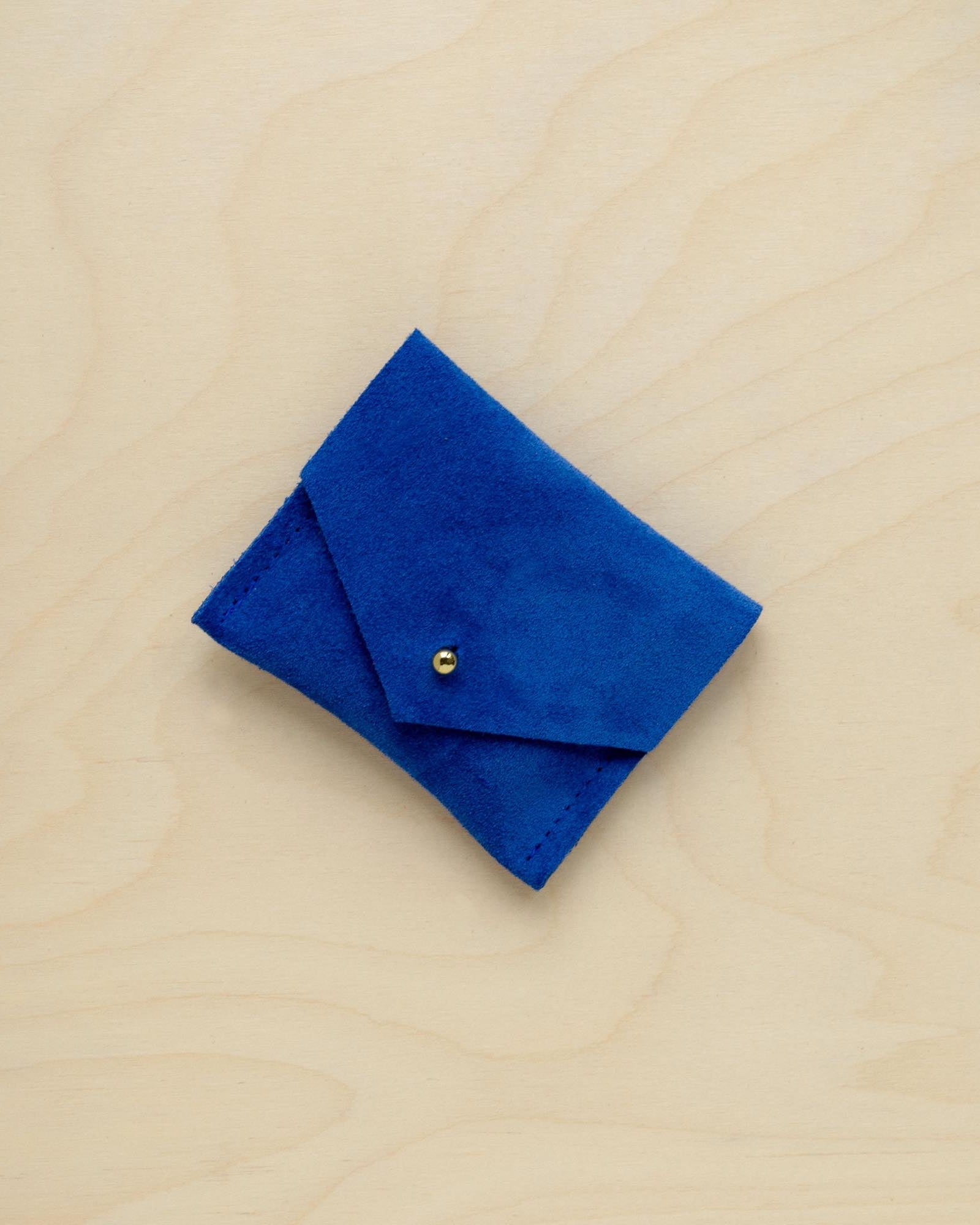 A suede Stitch Markers pouch in Ultramarine Blue. Complete with a stud for secure closing.