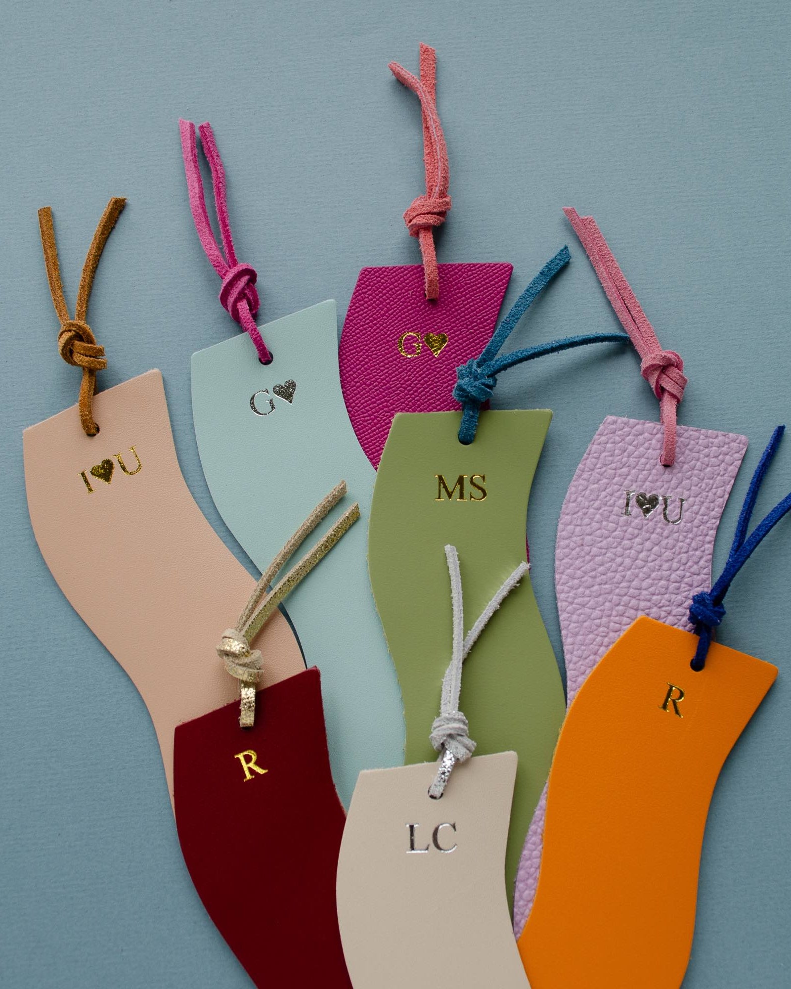 Colourful leather bookmarks on a blue background.