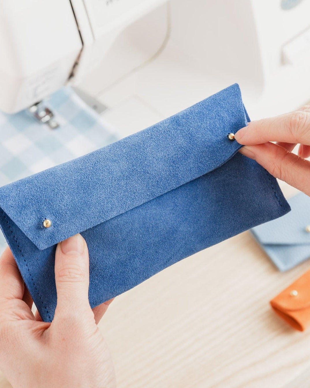 A suede double stud notions pouch in Cobalt Blue. Complete with studs for secure closing.