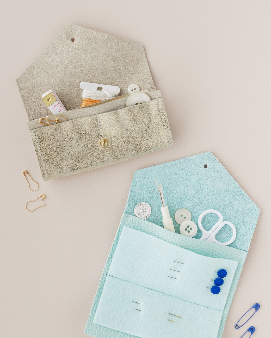 Gold and turquoise sewing case with integral felt for sewing needles.